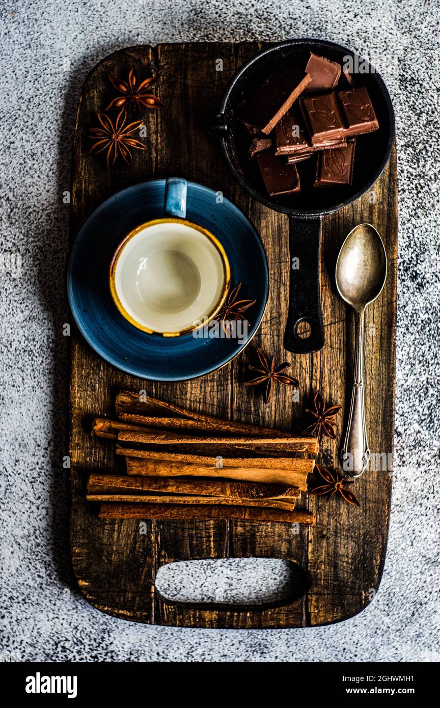 Vista dall'alto degli ingredienti per la preparazione di cioccolata calda su un tagliere Foto Stock