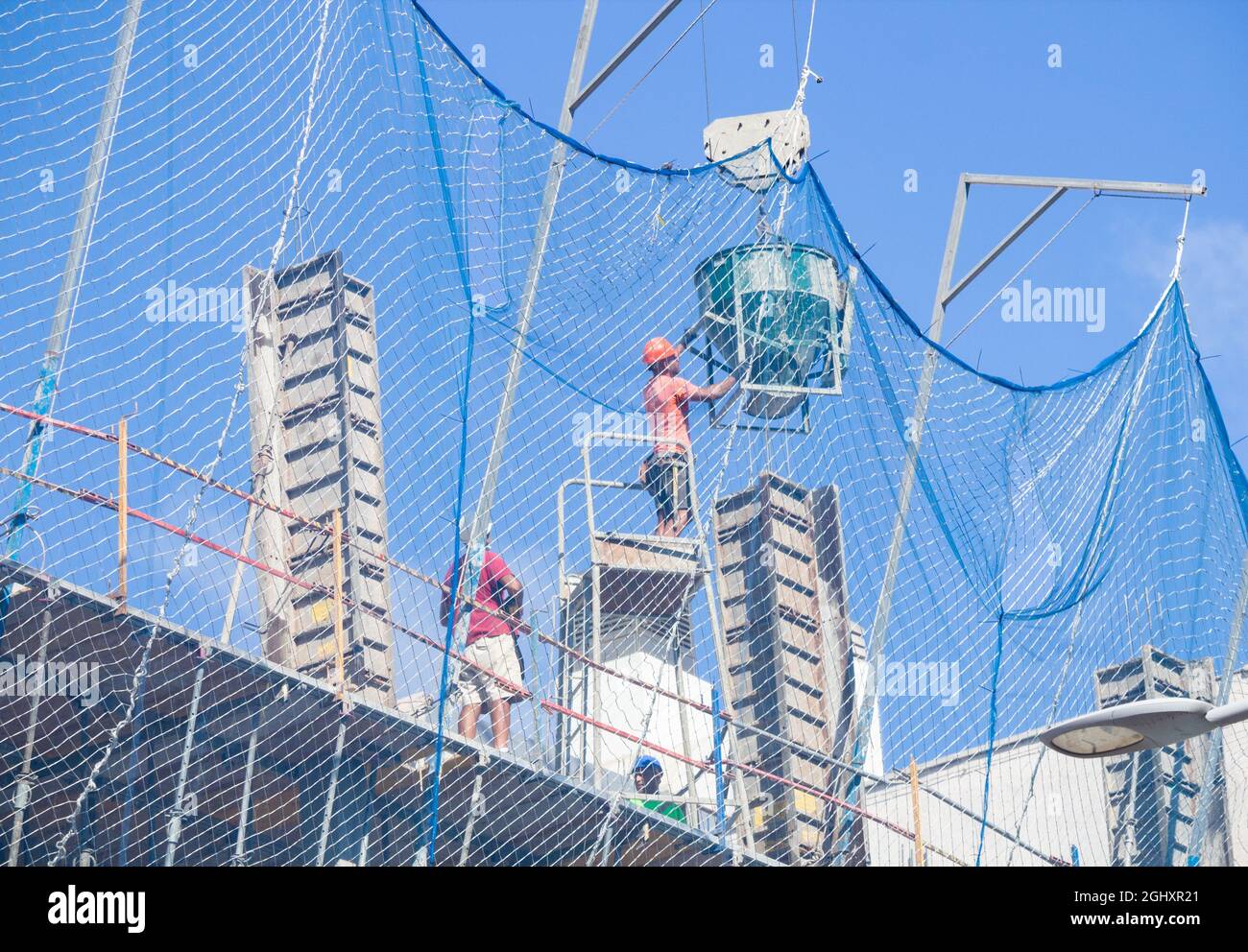 lavoratore, uomo di lavoro, versando calcestruzzo su cantiere. Foto Stock