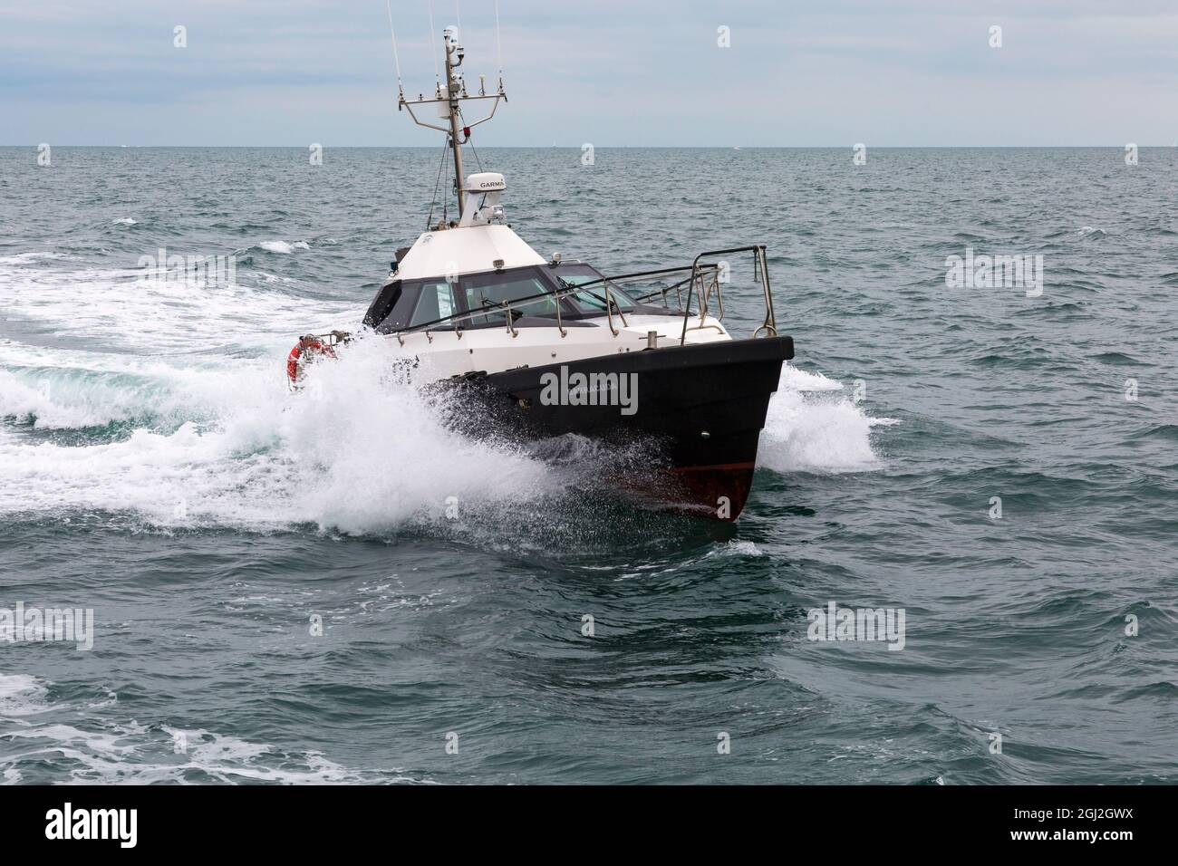 La barca pilota Barracuda saluta la nave che entra a Poole Harbour, Poole, Dorset UK nel mese di agosto Foto Stock