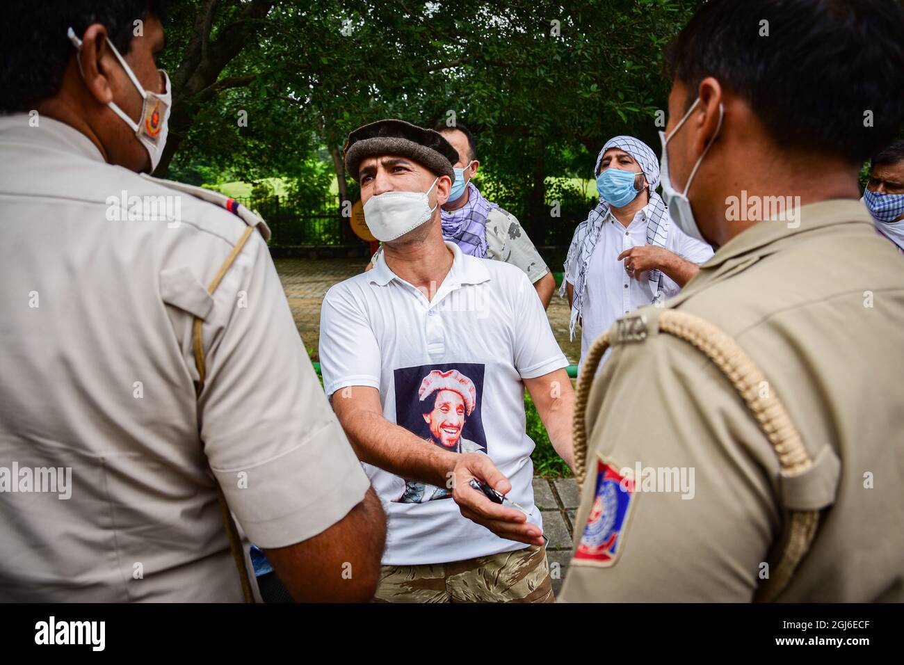 New Delhi, India. 9 settembre 2021. Un rifugiato afghano che indossa una t-shirt con una foto dell'ex comandante Mujahideen ucciso Ahmad Shah Massoud, parla con un poliziotto dopo che gli è stato negato il permesso di tenere una protesta presso l'ambasciata pakistana a Nuova Delhi. Credit: SOPA Images Limited/Alamy Live News Foto Stock