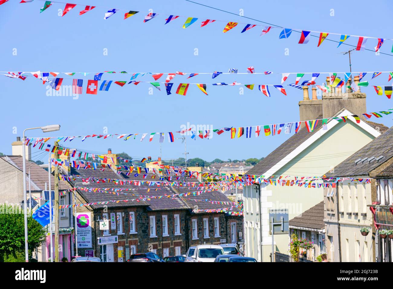 Bunting fatto da bandiere internazionali festoon il villaggio di Strangford, County Down, Irlanda del Nord, Regno Unito, Regno Unito. Foto Stock
