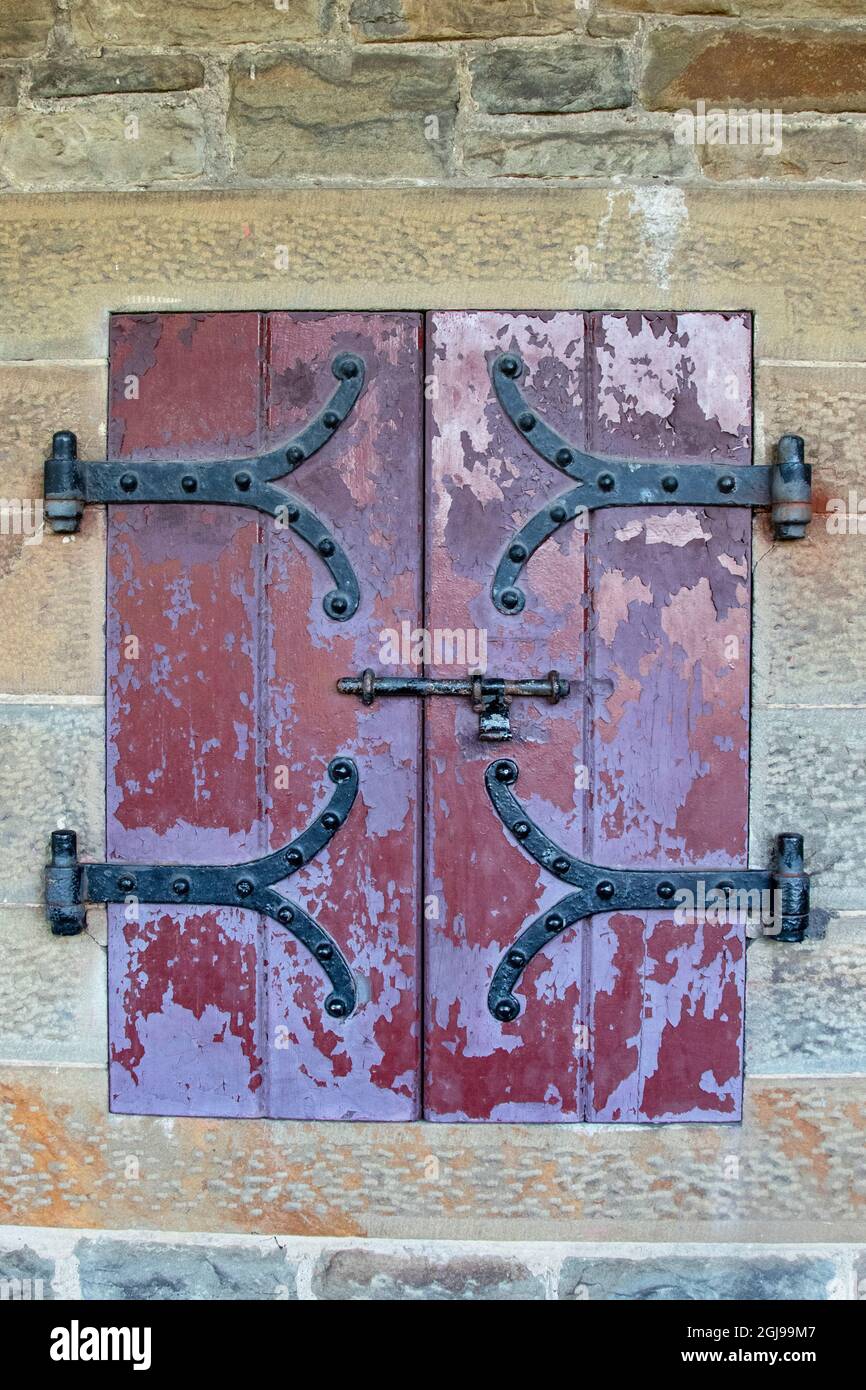 Le porte con cerniere in ferro battuto si trovano in un passaggio all'aperto presso il Castello di Cardiff, Galles. Foto Stock