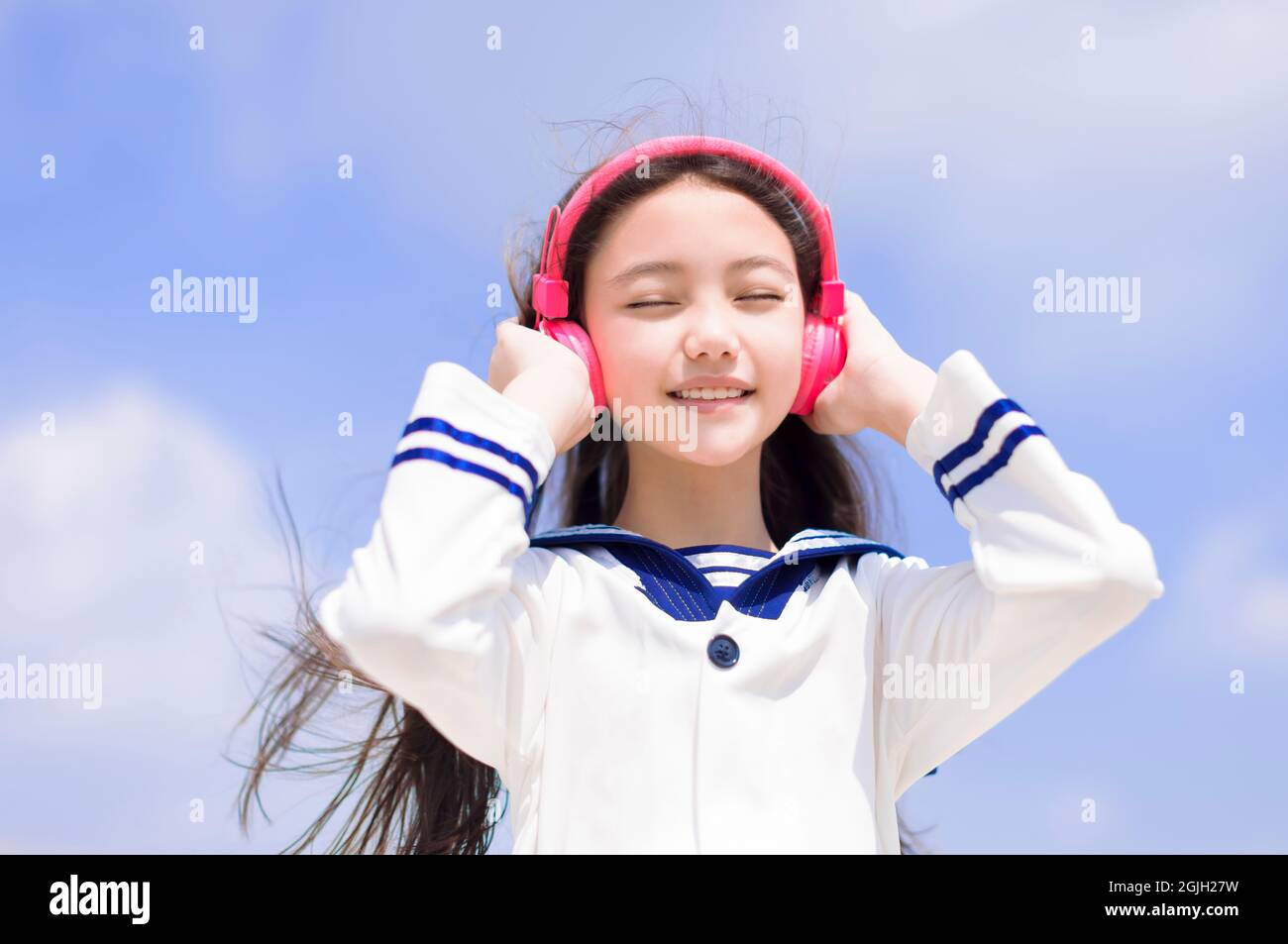felice studentessa ragazza godere ascoltare la musica con le cuffie Foto Stock