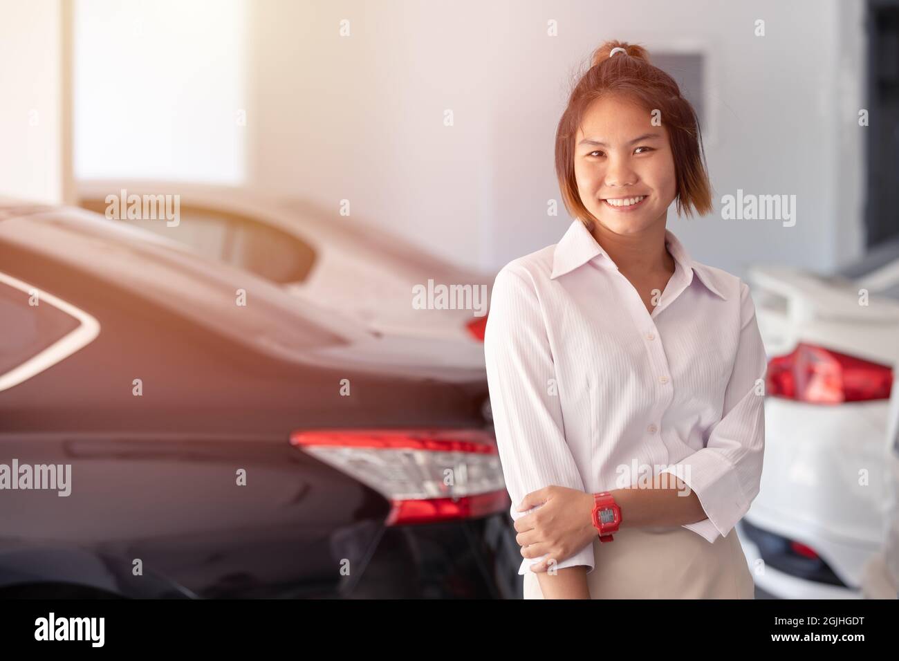 Giovani donne d'affari in piedi con l'auto per il cliente auto servizio garage sorriso felice Foto Stock