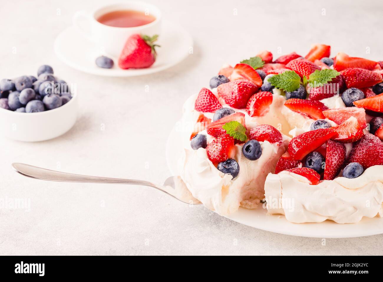 Deliziosa torta Pavlova con fragola fresca e mirtillo, fuoco selettivo Foto Stock