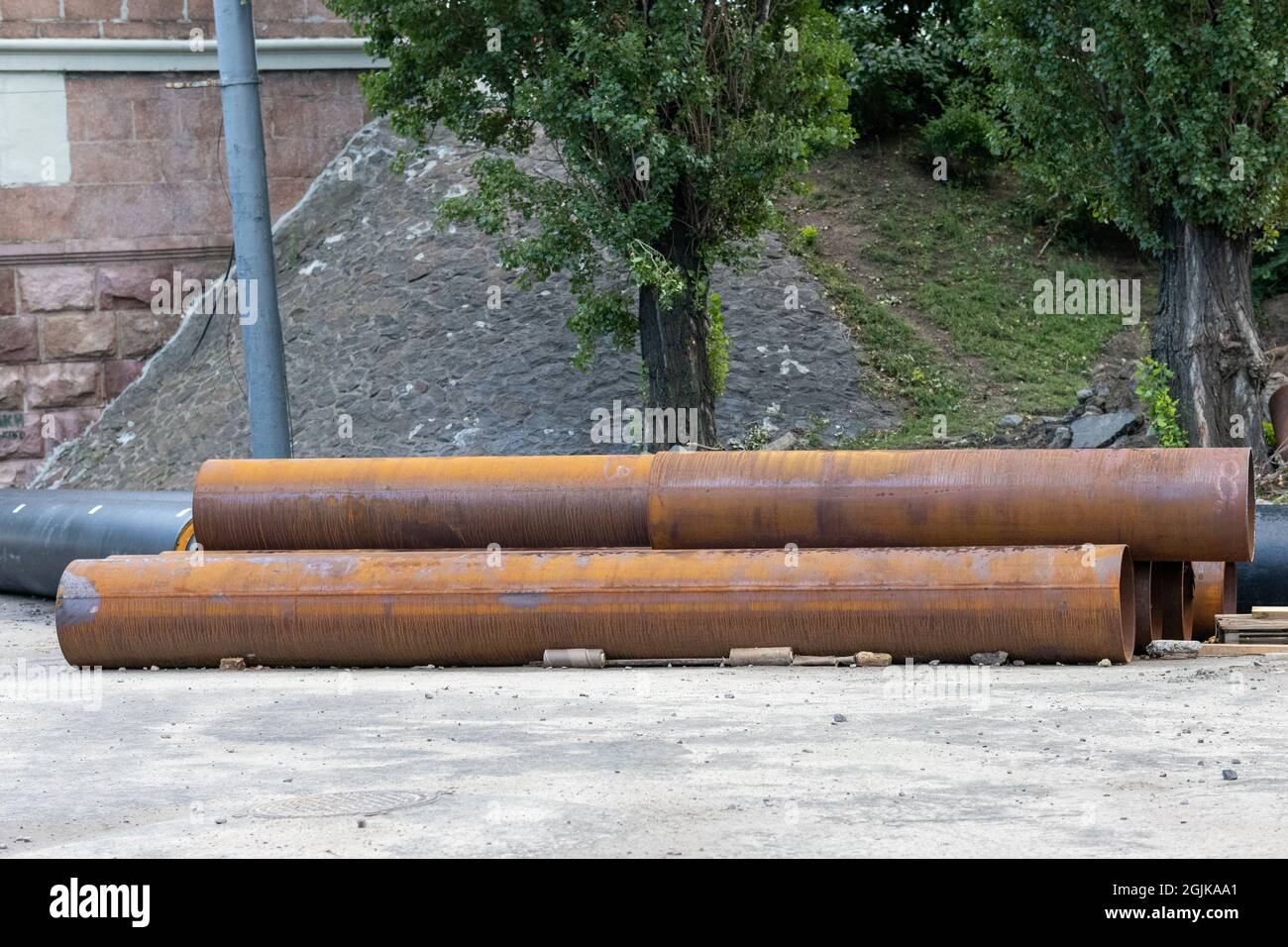 Grandi tubi dell'acqua arrugginiti sul cantiere Foto Stock