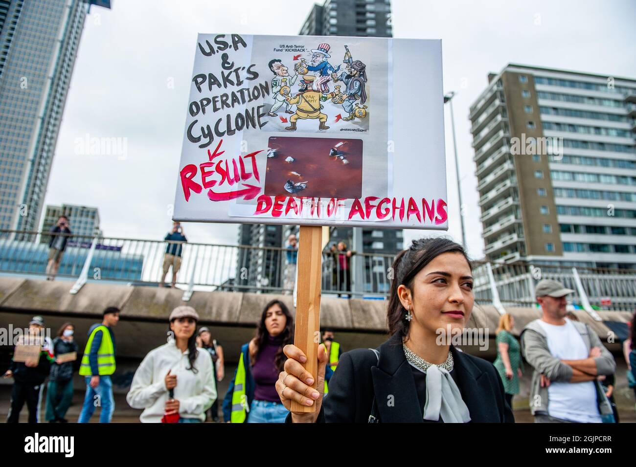 Una donna afghana tiene un cartello contro la guerra in Afghanistan durante la manifestazione. La Federazione delle organizzazioni residenti afghane in Europa (FAROE) ha organizzato manifestazioni in diverse città europee il 11 settembre, esattamente vent'anni fa che gli alleati della NATO sono andati in Afghanistan dopo gli attacchi terroristici del 9/11 contro gli Stati Uniti. A Rotterdam, circa cento persone si sono riunite per dichiarare la propria solidarietà all'Afghanistan che continua a lottare per un Afghanistan libero e democratico dopo che l'esercito degli Stati Uniti ha lasciato il paese alcune settimane fa. Foto Stock