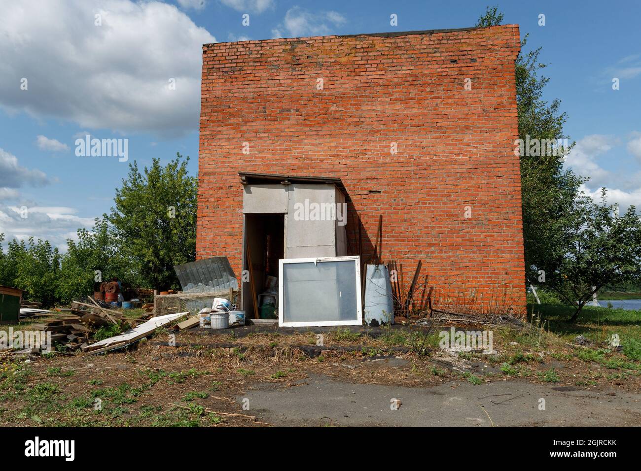 Edificio in fienile disabitato, annesso agricolo in mattoni rossi abbandonato. Foto Stock