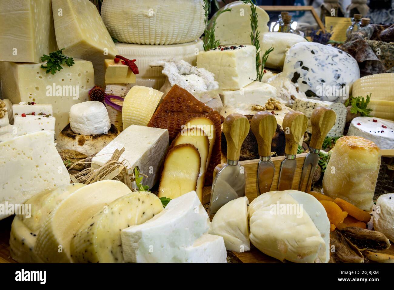 Ampia varietà di formaggi locali e tradizionali preparati per la presentazione. Formaggi organici impilati e lame da taglio. Prelibatezze gourmet Foto Stock