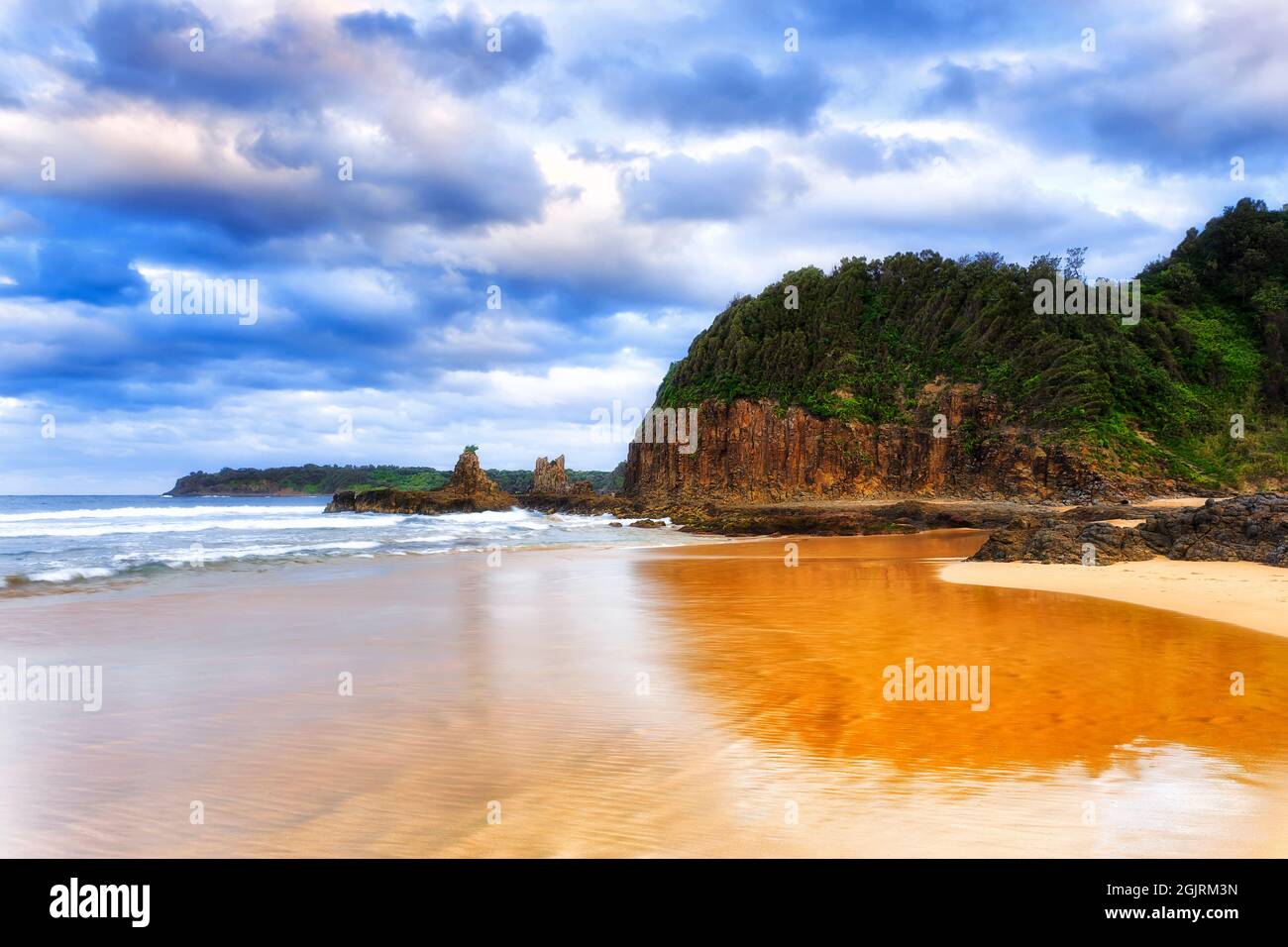 Scenico promontorio basalto al largo della spiaggia di Jones a Kiama Bombo sulla costa meridionale dell'Australia, New South Wales. Tramonto sul mare con la famosa roccia della cattedrale. Foto Stock