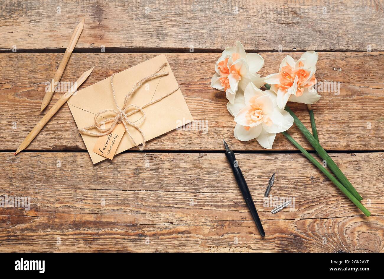 Busta con testo LAVANDA LAVANDULA, penne e fiori su sfondo di legno Foto Stock