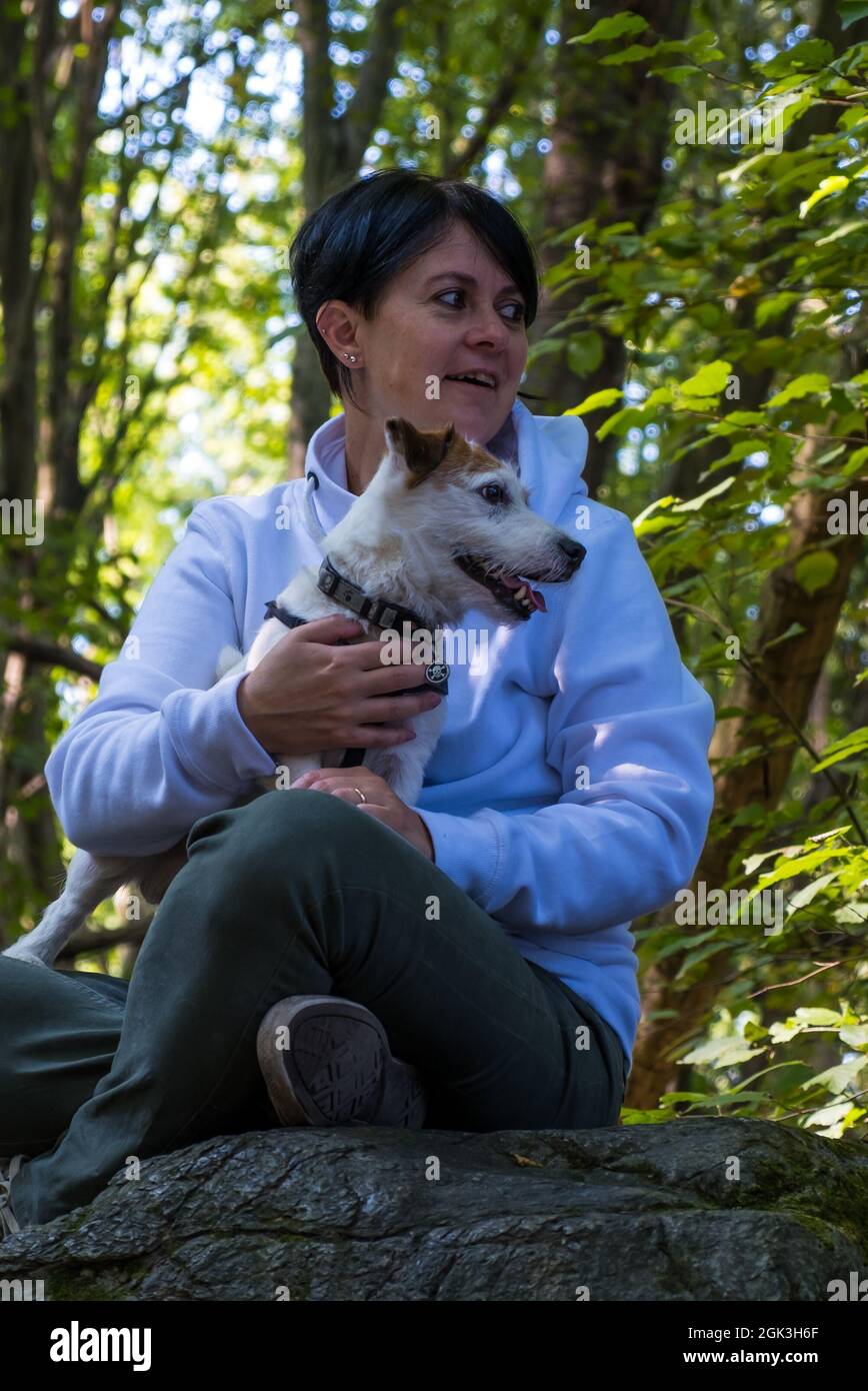 Donna con Jack Russel Terrier in un forrest verde Foto Stock