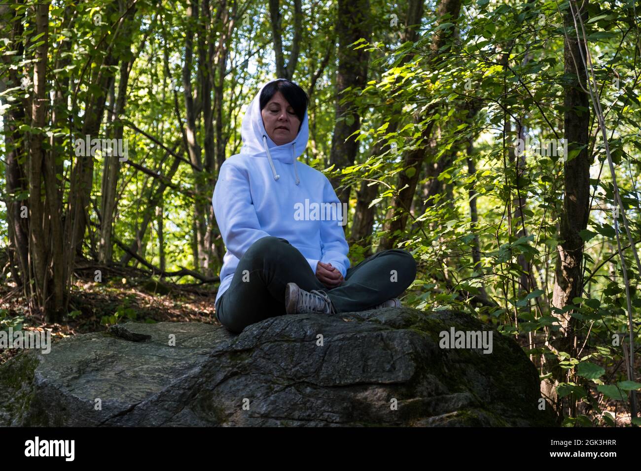 Pensiero serio della giovane donna in una foresta Foto Stock