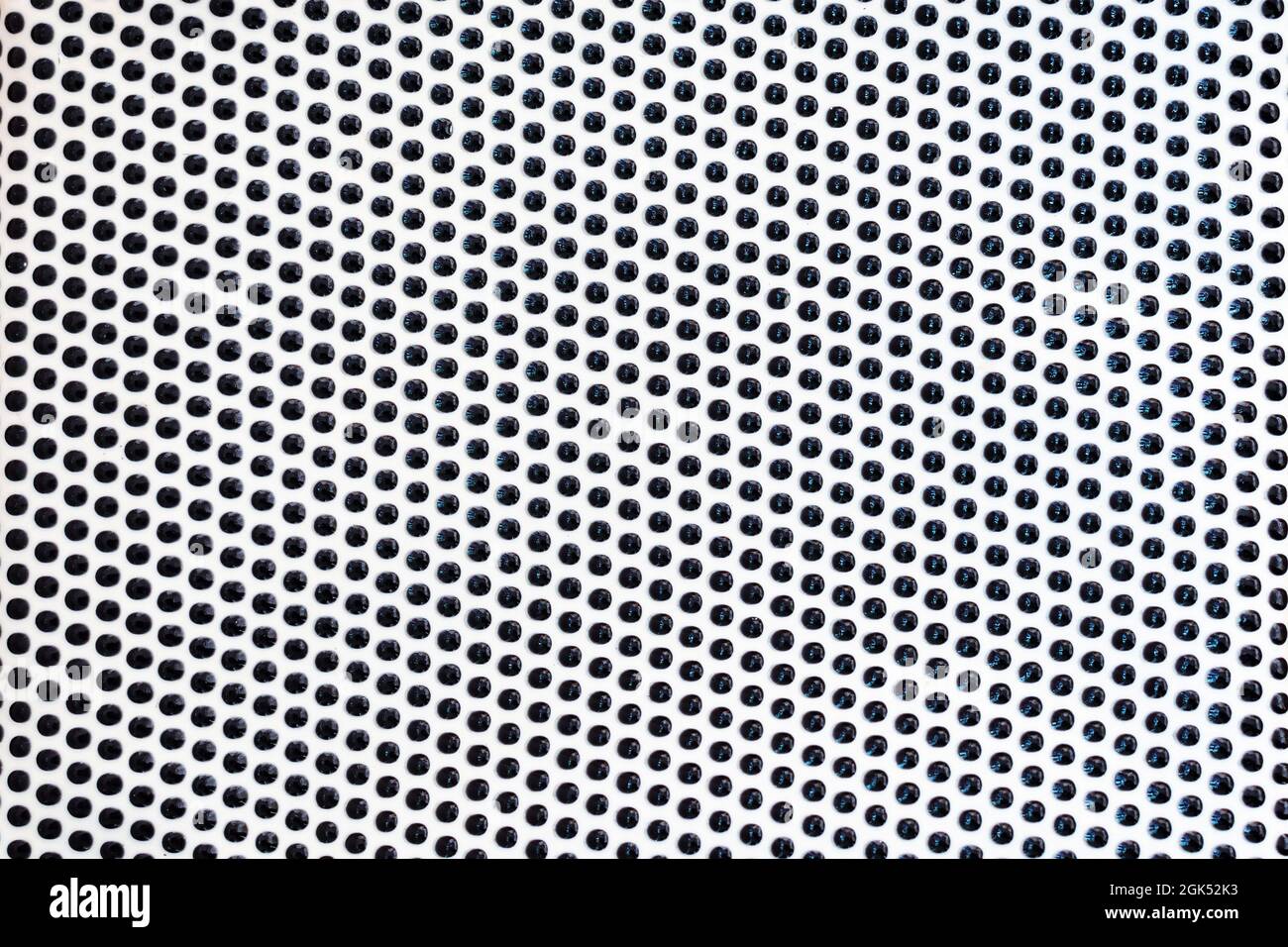 Ripetizione di linee di punti neri sulla superficie bianca come sfondo Foto Stock