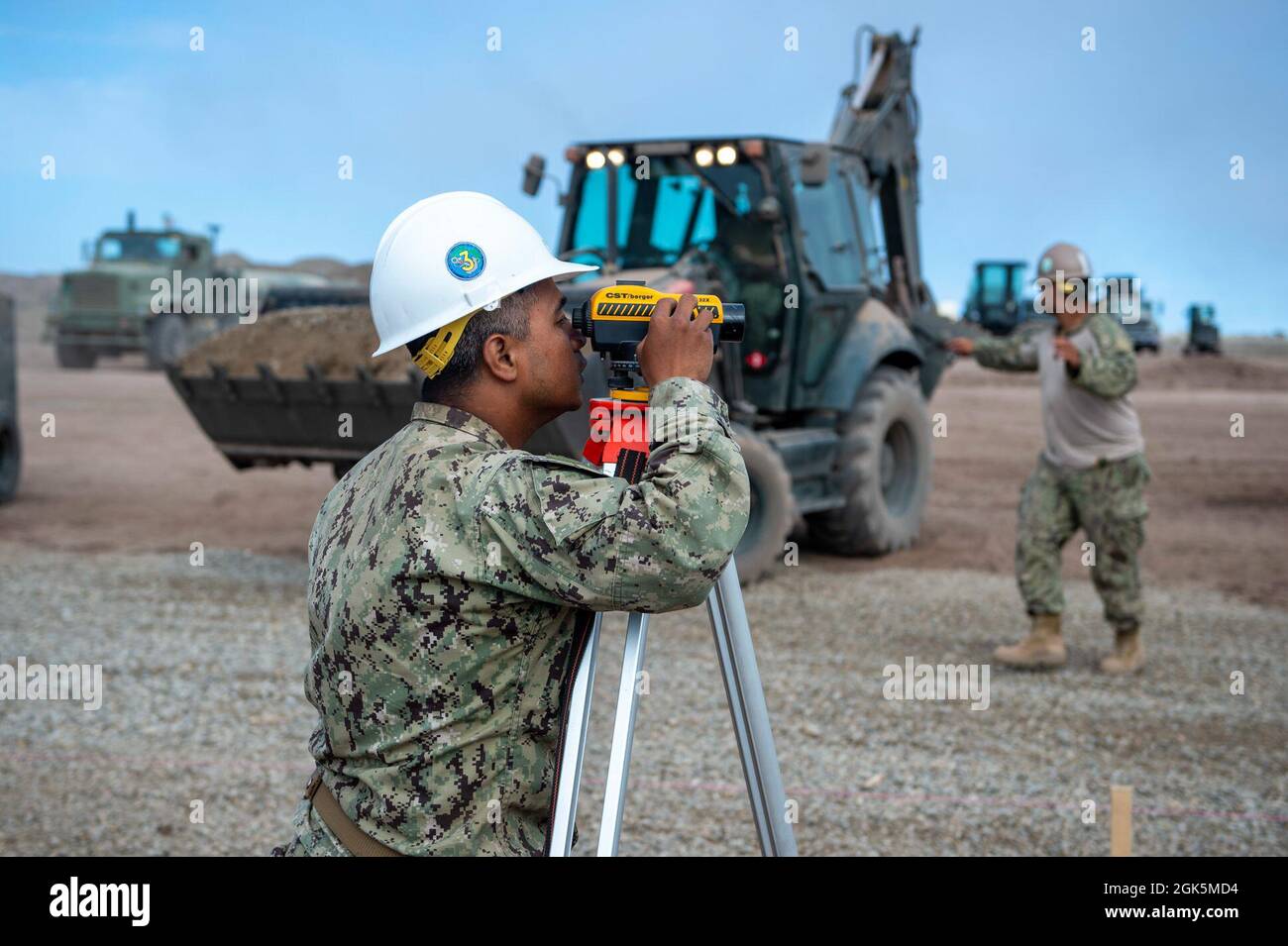 210809-N-TP832-3038 SAN CLEMENTE ISLAND, California (Agosto 9, 2021) Lt. Jefferson Bobo, assegnato a U.S. Naval Mobile Construction Battaglione 3, Esegue le misurazioni con un livello automatico per una base secondaria in calcestruzzo per un pattino in calcestruzzo da 150 piedi per 150 piedi per il decollo e l'atterraggio verticale mentre il battaglione conduce la costruzione e il supporto di Expeditionary Advanced base Operations e Advanced Naval base come parte del PUNTO DI SVOLTA dell'esercizio. IL PUNTO DI SVOLTA è un importante esercizio di preparazione alle operazioni di combattimento per la Pacific Naval Construction Force, progettato per supportare e consentire la manovra e la logistica della flotta. Foto Stock