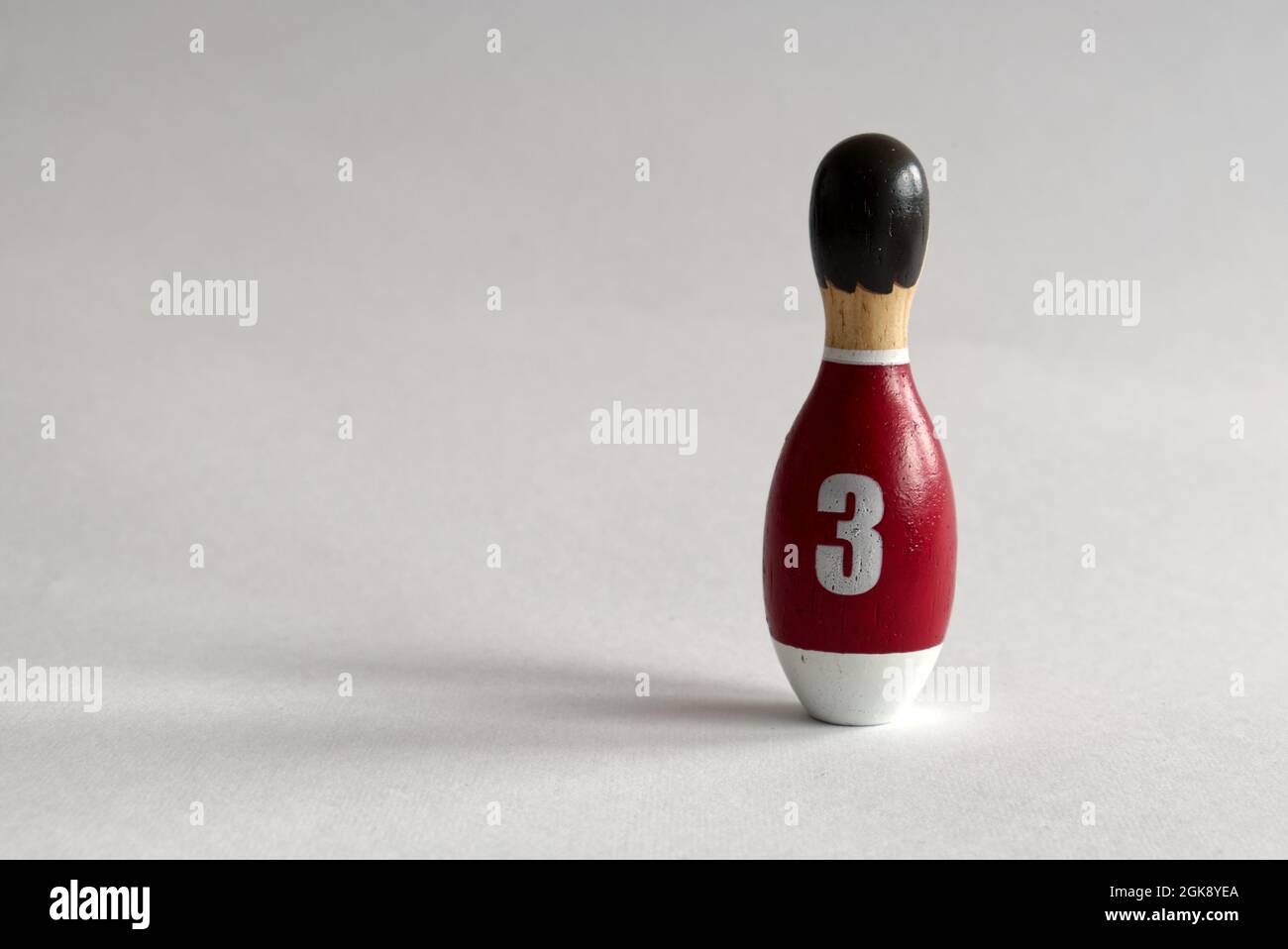 vista posteriore di un burattino in legno a forma di birilli con una maglietta numero tre Foto Stock