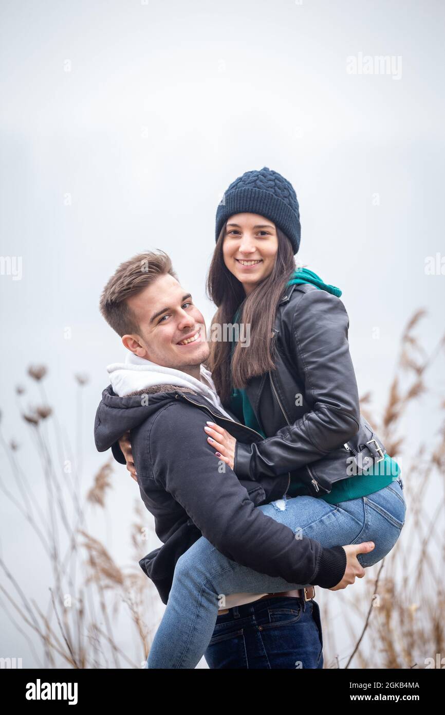 Giovane coppia che si diverte in natura in una giornata invernale di nebbia Foto Stock