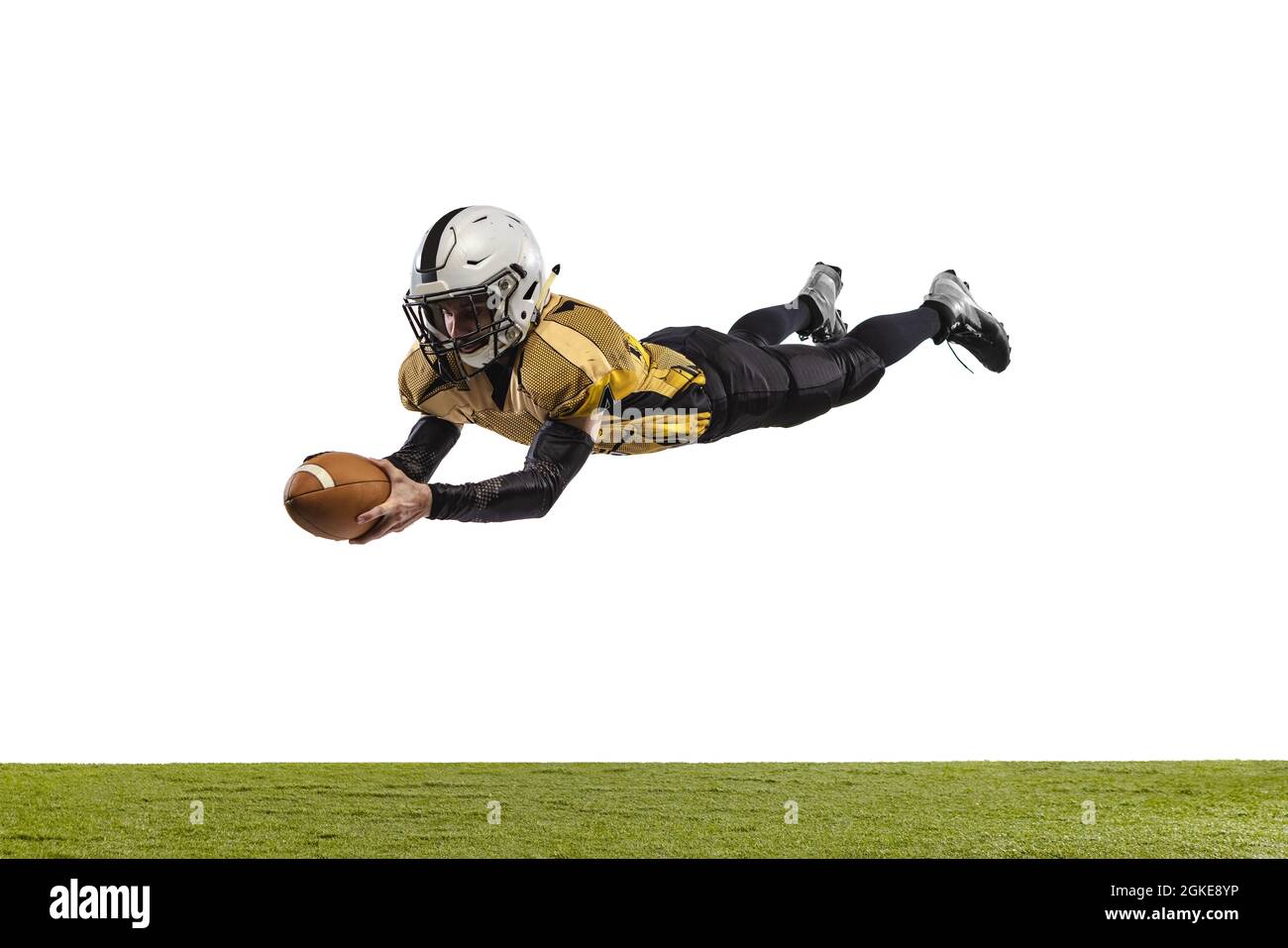 Ritratto a tutta lunghezza del giocatore di football americano professionista in uniforme speciale che cattura una palla isolata su sfondo bianco erba pavimento Foto Stock
