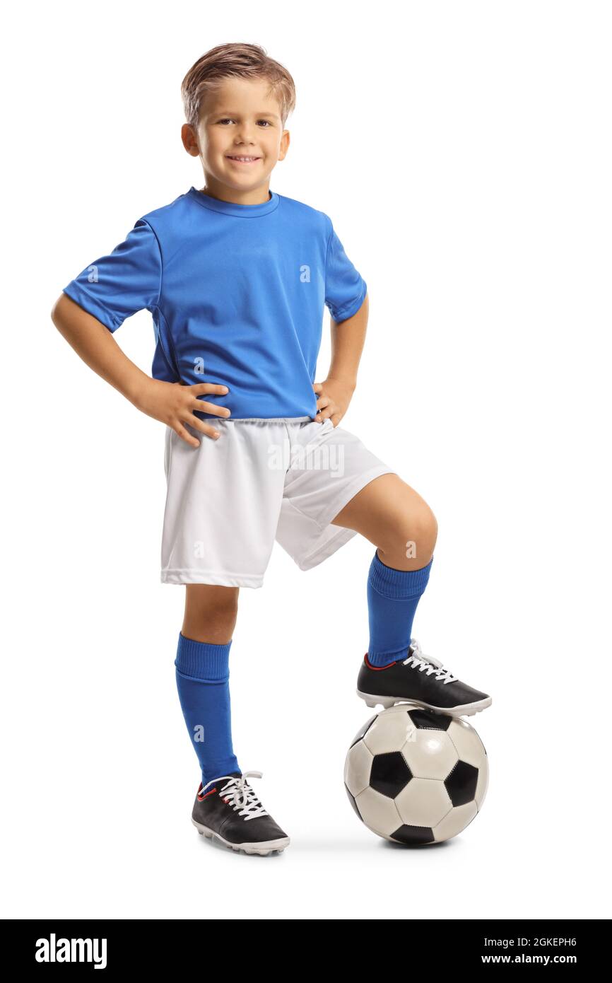 Felice ragazzino in una maglia sportiva che si muove su una palla da calcio  isolata su sfondo bianco Foto stock - Alamy