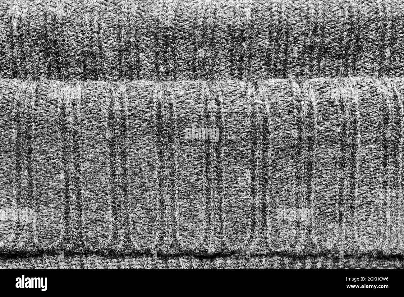 Texture sfondo foto di tessuto lavorato a maglia color grigio. Foto Stock