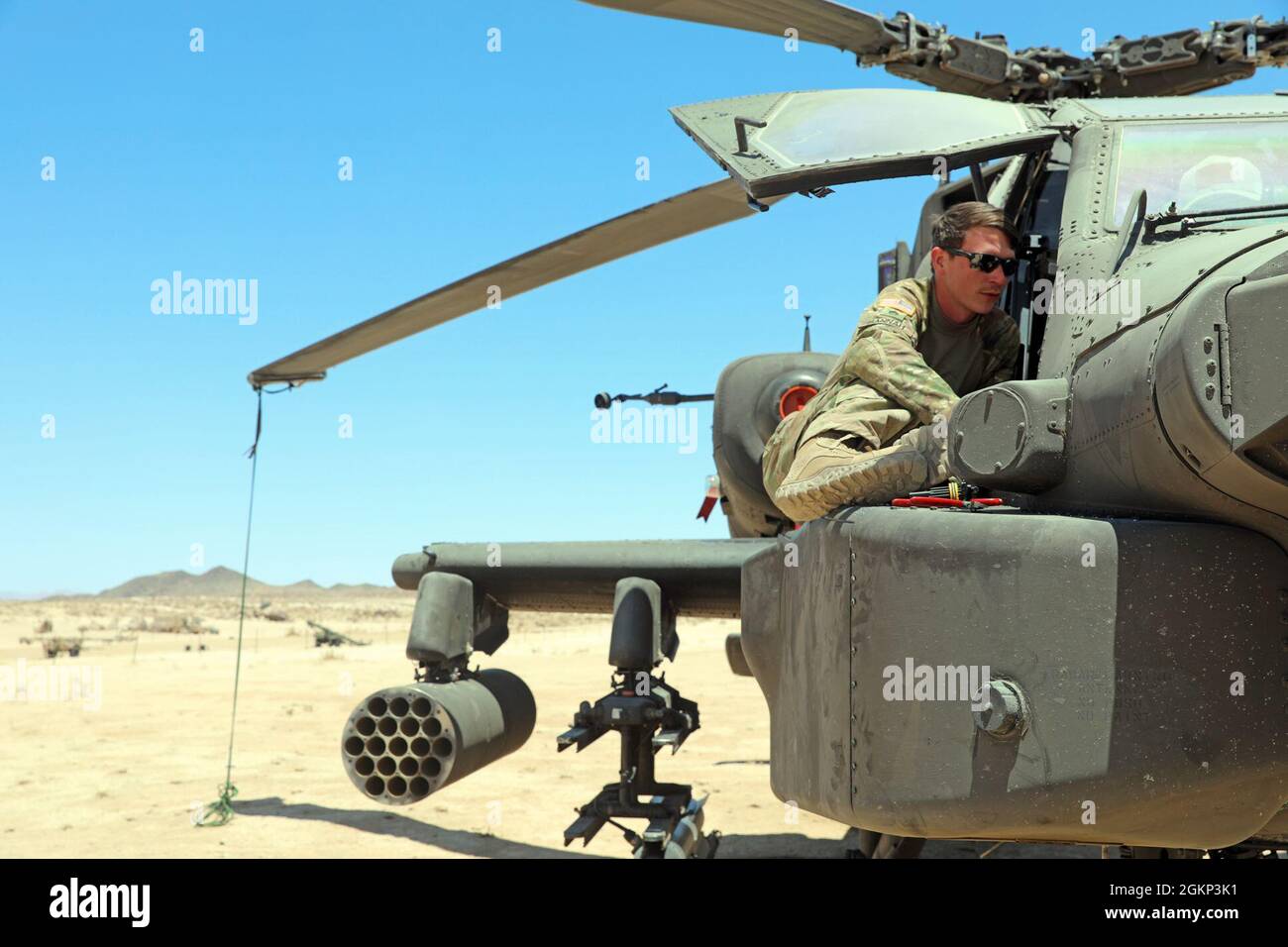 Personale Sgt. Austin Hannah, un riparatore di sistemi avionici, con il 1° Battaglione, 149° Regiment Aviazione, la Guardia Nazionale dell'Esercito del Mississippi, effettua un controllo di manutenzione su un AH-64D Apache Longbow al National Training Center, Fort Irwin, California, 10 giugno 2021. Hannah, un nativo di Tupelo, Mississippi, è con la sua unità che sostiene la 155a squadra di combattimento di Brigata Armored alla NTC. Foto Stock