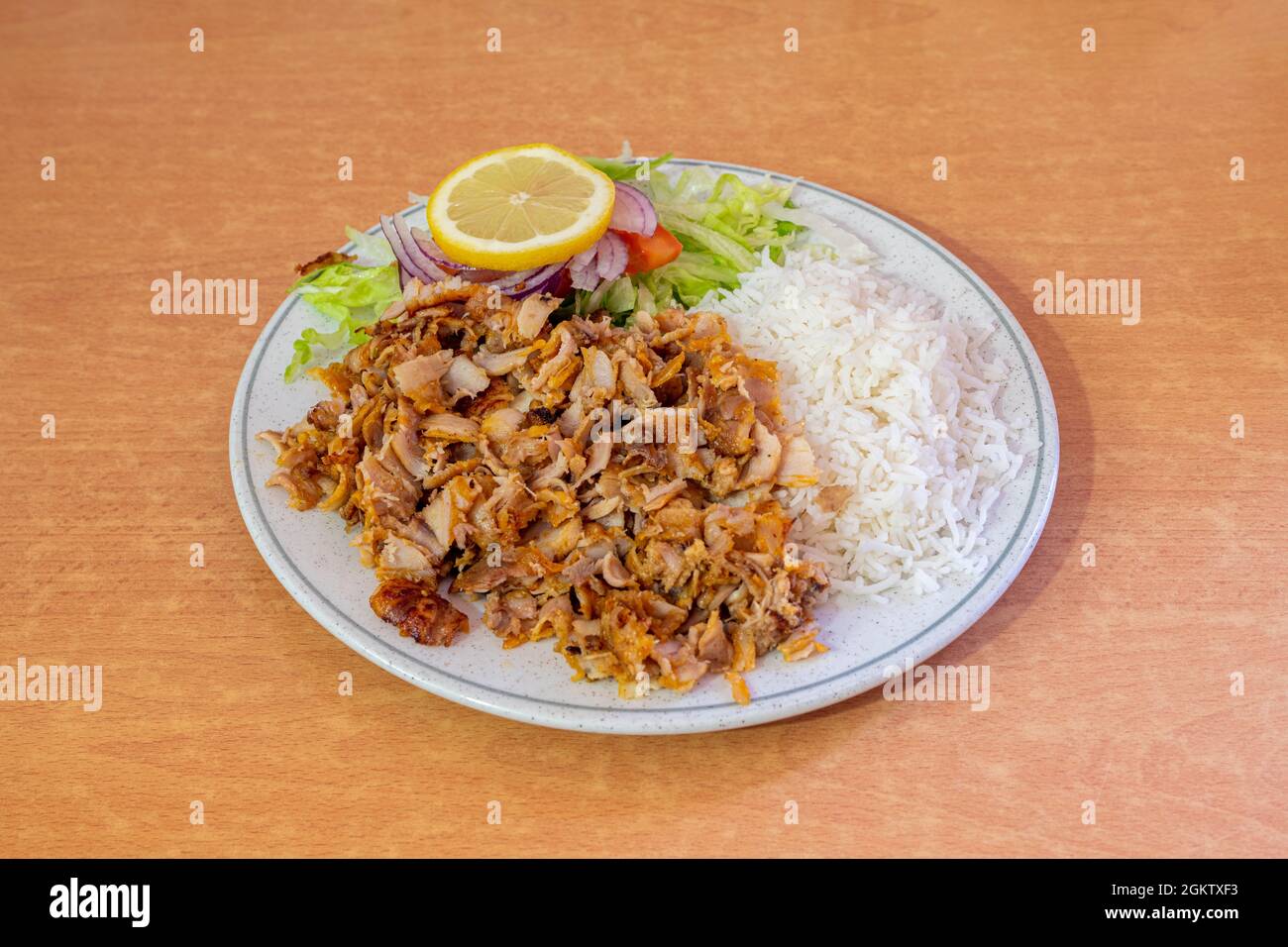 Menu piatto di kebab misto guarnito con riso basmati e insalata con cipolla rossa e pomodoro al limone per condimento Foto Stock