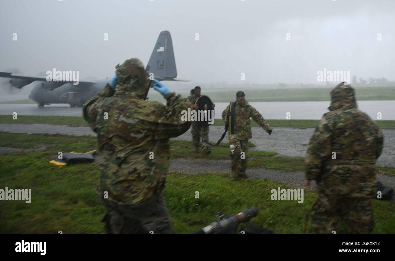 US Air Force Airmen off-load tubi carburante e attrezzature da un C-130J Super Hercules 21 luglio 2021, presso Tinian International Airport, Tinian, durante Pacific Iron 2021. Pacific Iron 2021 è un'operazione di occupazione dinamica delle forze aeree del Pacifico per proiettare le forze nell'area di responsabilità dell'USINDOPACOM a sostegno della strategia di difesa nazionale del 2018 che ha invitato i militari ad essere una forza più letale, adattiva e resiliente. Foto Stock