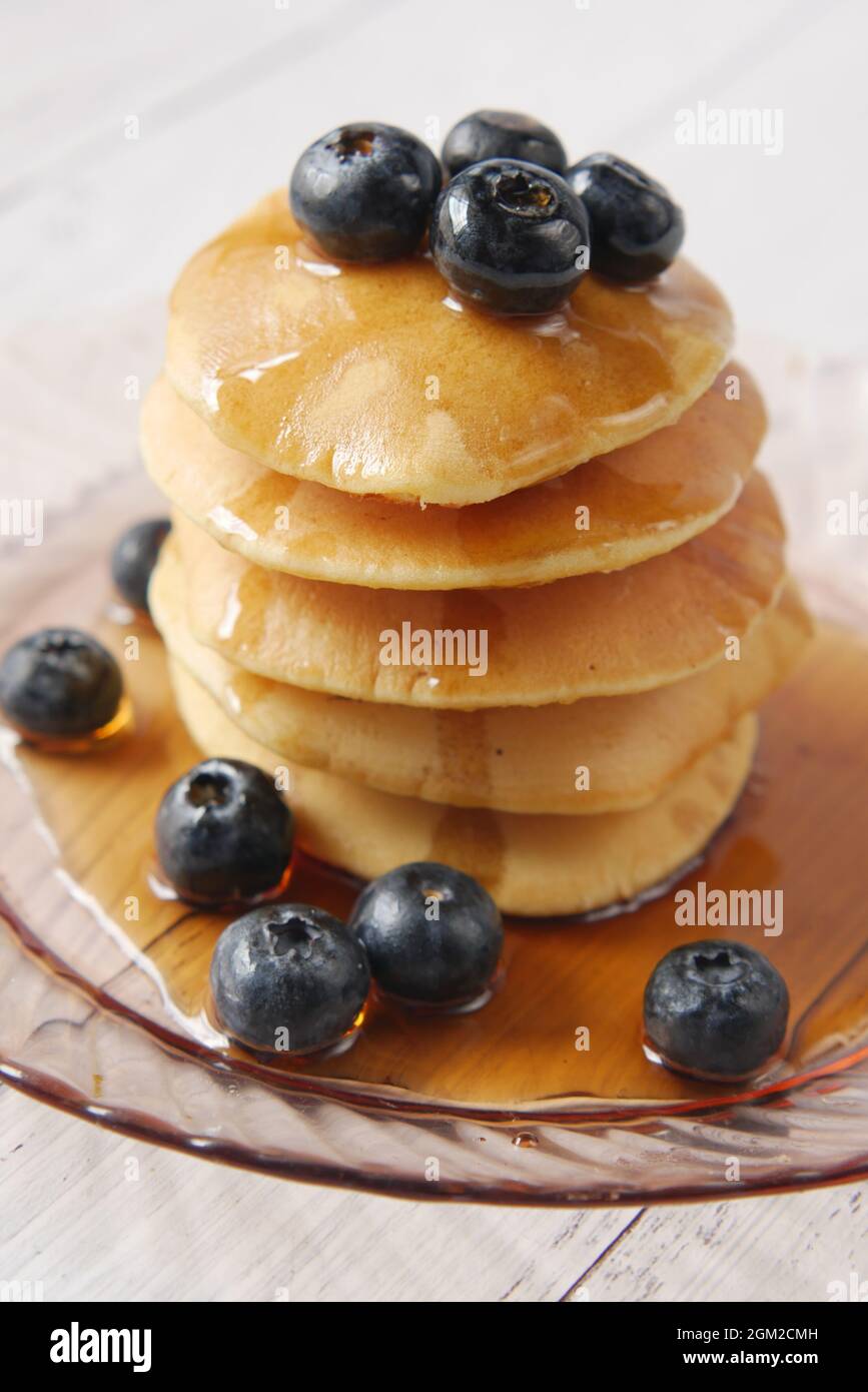 Pancake con bacche fresche e sciroppo d'acero su un piatto, Foto Stock