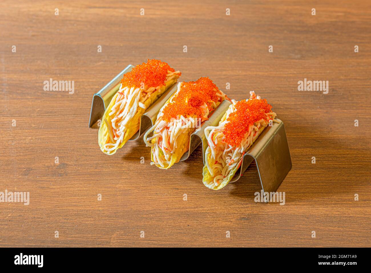 Tacos di pesce con carne di surimi grattugiata, capriolo di pesce sulla  parte superiore e supporto in metallo Foto stock - Alamy