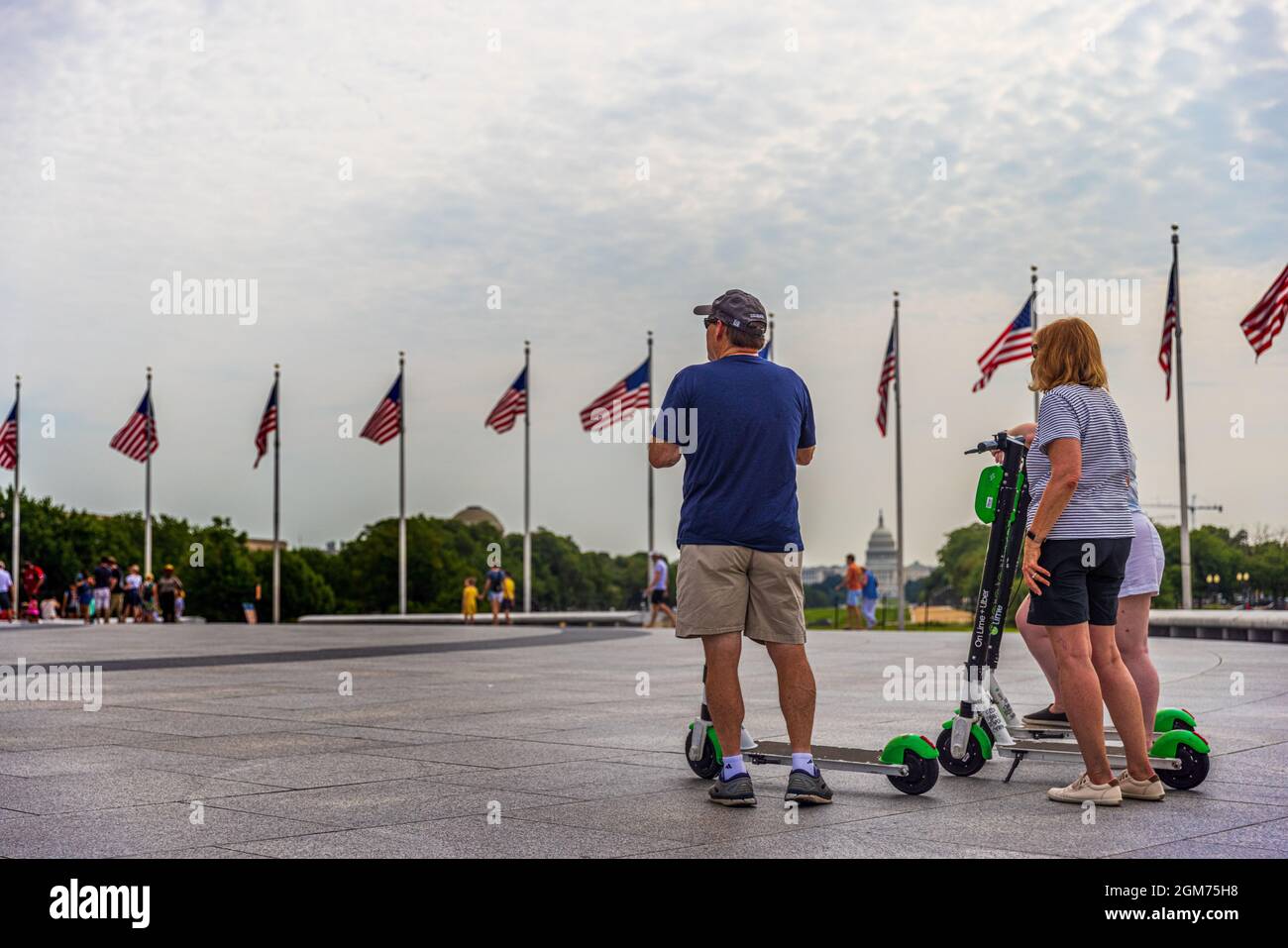 Washington, D.C. / USA - 14 agosto 2021: Un gruppo di anziani che visitano Washington Monument utilizzando scooter a noleggio Lime Foto Stock