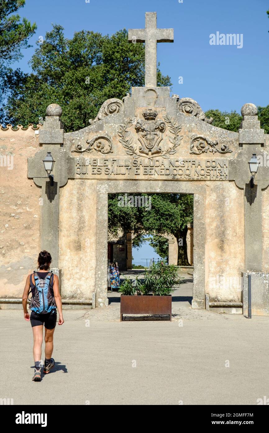 Donna runner all'ingresso del Santuario di nostra Signora di cura, Puig de cura, Algaida, Mallorca, Spagna. Foto Stock