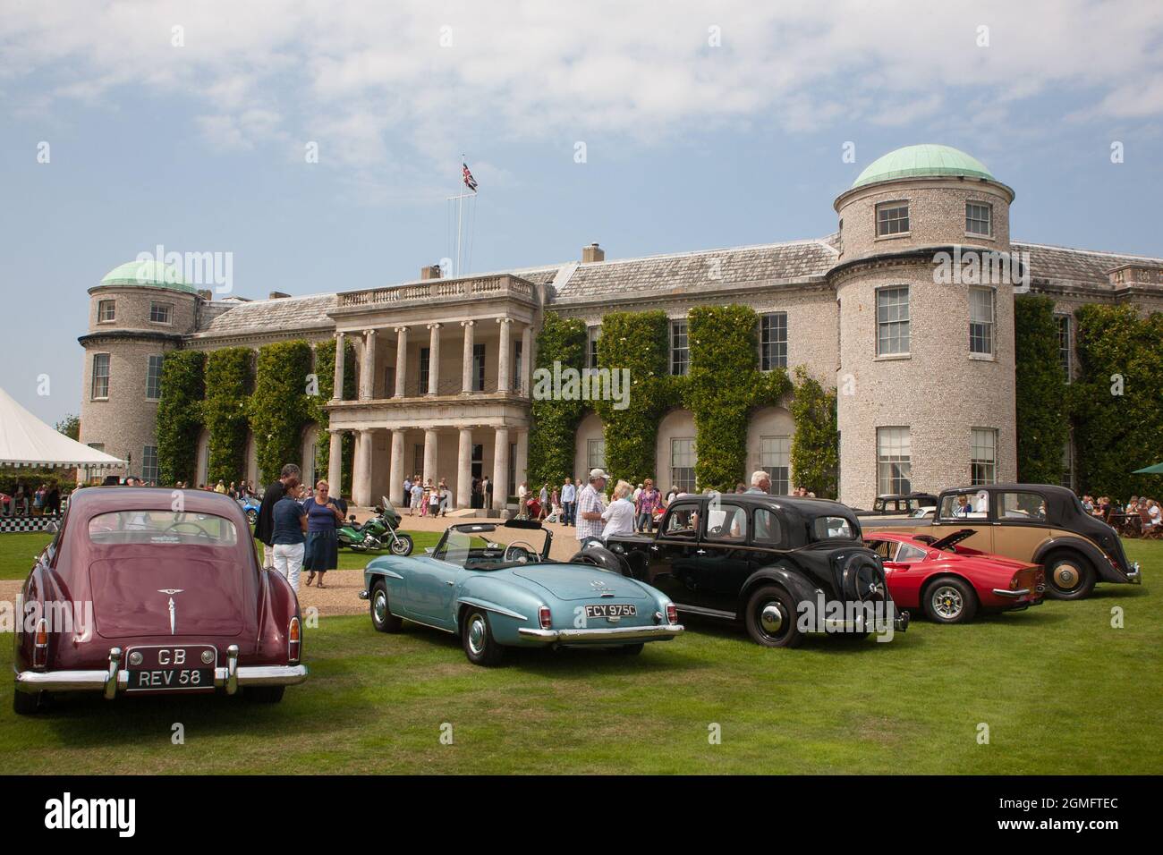 Auto d'epoca classiche parcheggiate di fronte a Goodwood House, West Sussex, Inghilterra, Regno Unito Foto Stock