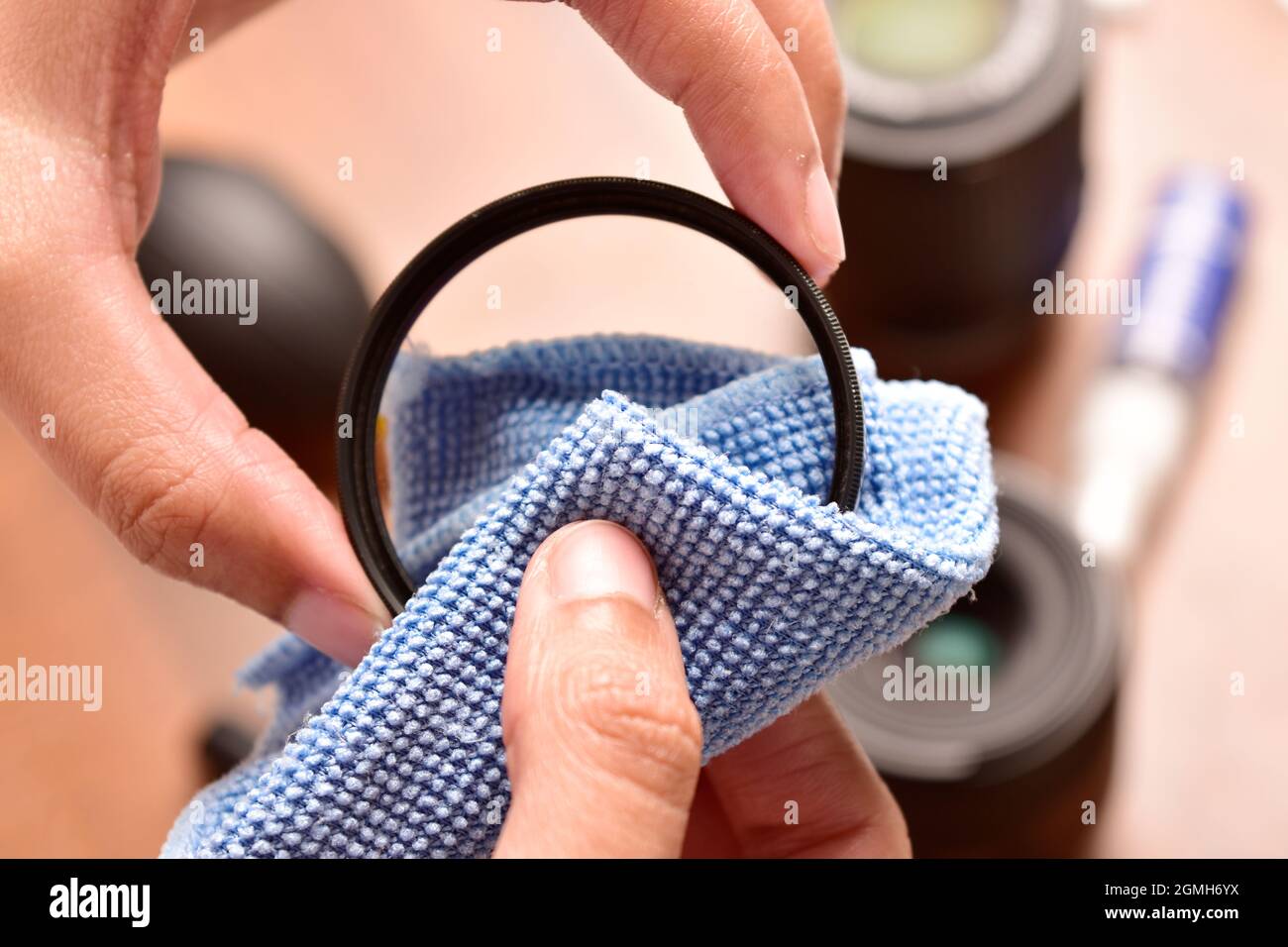 filtro di protezione dell'obiettivo della fotocamera pulito con un panno in microfibra Foto Stock