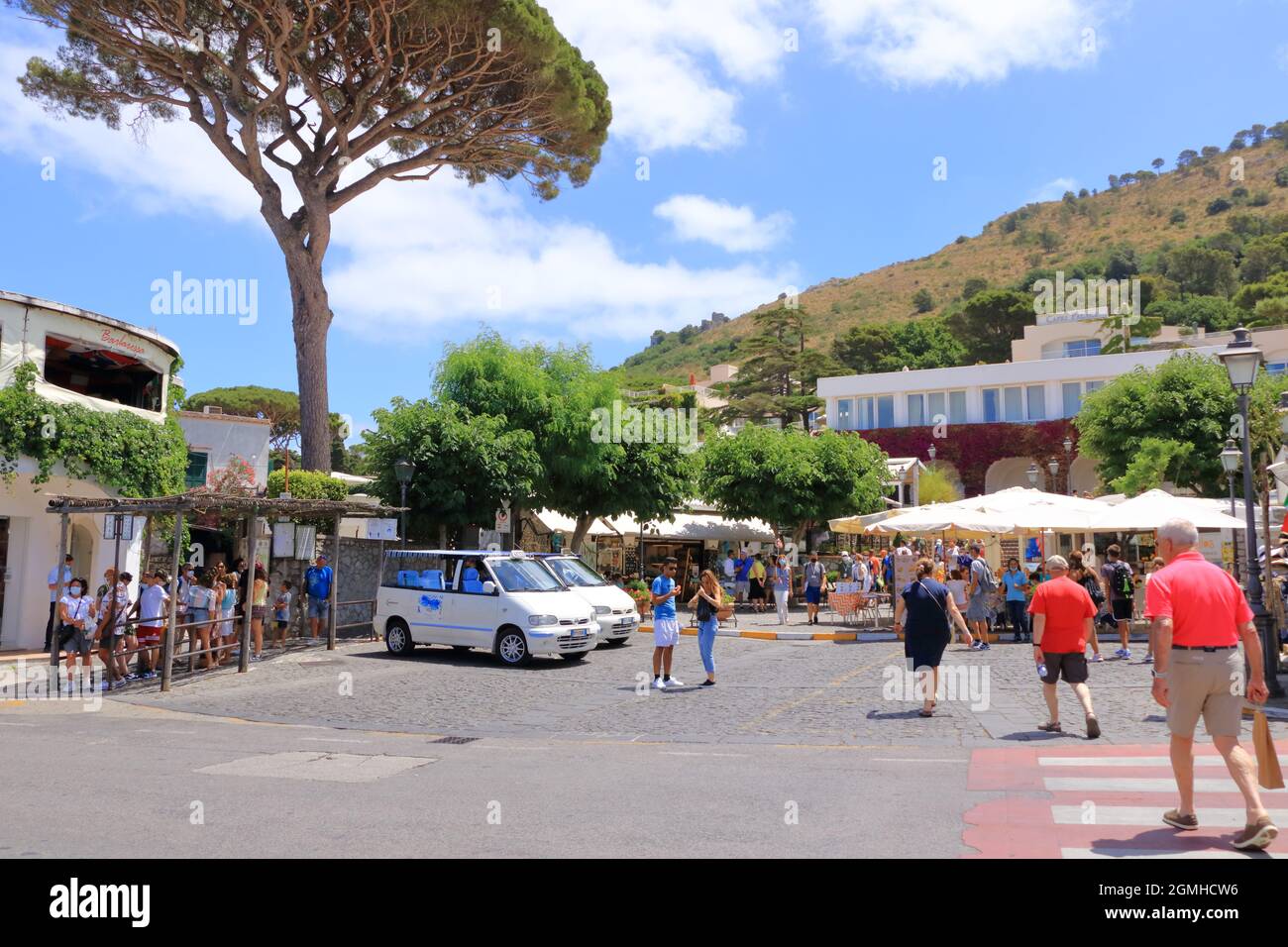 14 2021 luglio - Capri, Italia: Bella stradina della città di Anacapri, città mediterranea con alberi fioriti e case bianche Foto Stock