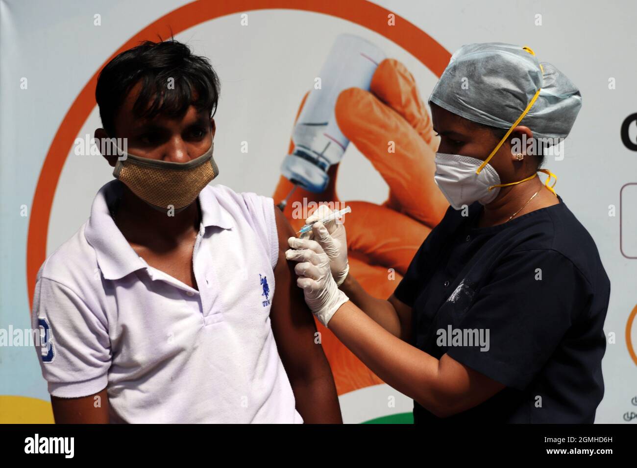 Chennai, Tamil Nadu, India. 19 Settembre 2021. Un operatore sanitario inocula un passeggero con una dose di vaccino contro il coronavirus Covid-19 in un campo di vaccinazione temporaneo allestito all'interno di una stazione ferroviaria di Chennai. Il secondo mega campo di vaccinazione per la vaccinazione del Covid-19 è attualmente in fase di organizzazione e il numero di vaccinazioni sta gradualmente aumentando nel Tamil Nadu. Finora sono state vaccinate circa 92 persone lakh. (Credit Image: © Sri Loganathan/ZUMA Press Wire) Foto Stock