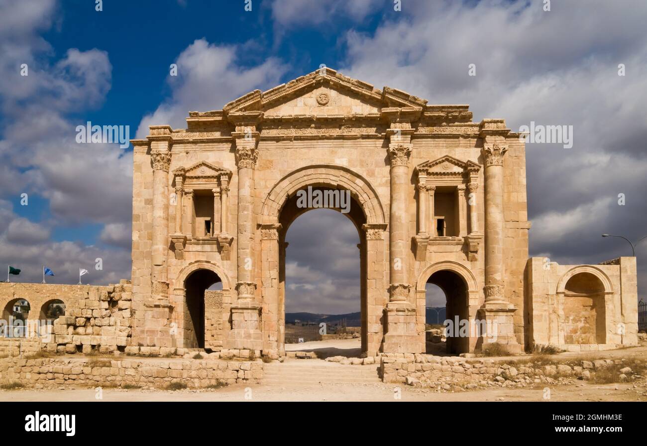 Arco di Adriano nell'antica città romana di Jerash in Giordania. Costruito nel 129 d.C. per onorare l'imperatore in visita. Luce solare, bel contrasto di nuvole e blu Foto Stock
