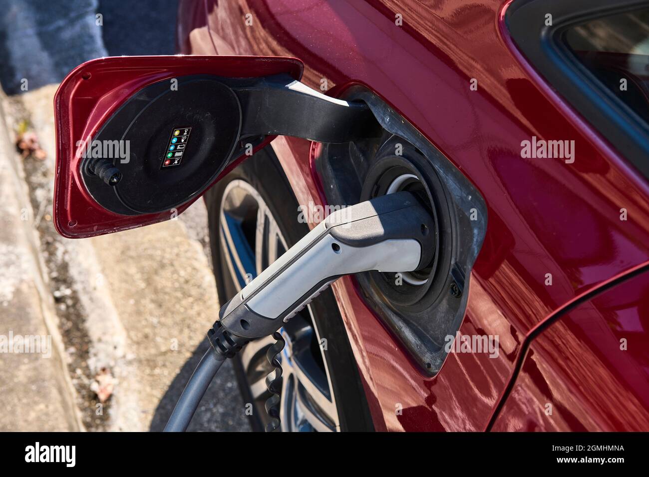 Alimentatore per auto elettrica di carica. Auto elettrica stazione di ricarica. Close up di alimentazione inserito in una macchina elettrica in carica. Foto Stock