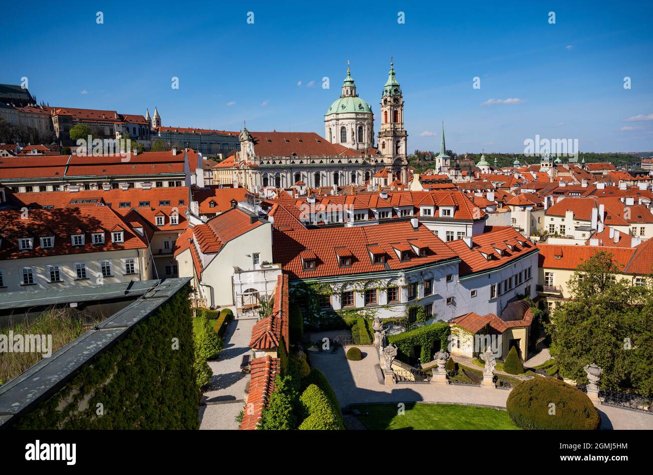 Vista dal giardino di Vrtbovska al tetto rosso della città minore di Praga, il curch di San Nicola e il complesso del castello di Praga, repubblica Ceca. Foto Stock