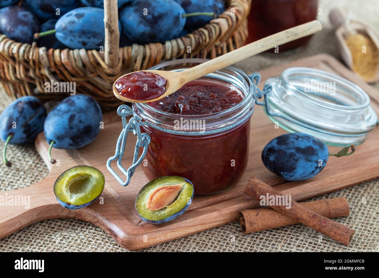 confettura di prugne in vetro e prugne fresche in cestello Foto Stock