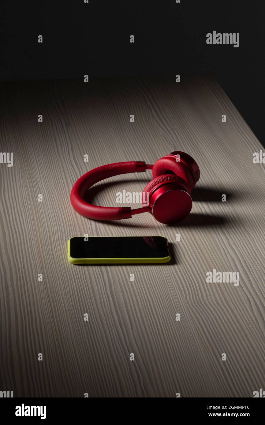 Cuffie e smartphone sul tavolo Foto Stock