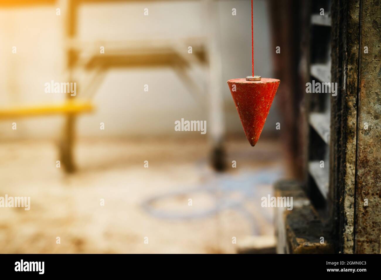 pendolo con prugna per trovare linea verticale Foto Stock