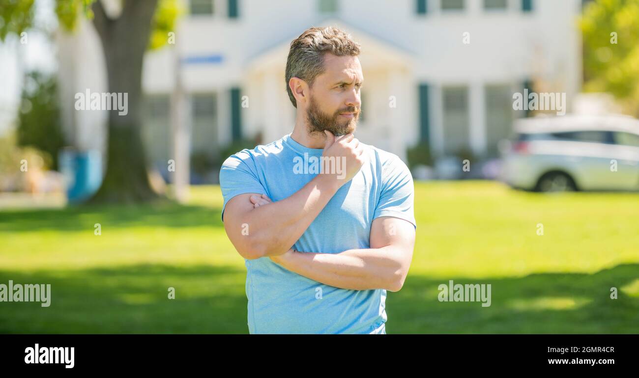 serio uomo maturo realtor in piedi all'aperto a casa, broker Foto Stock