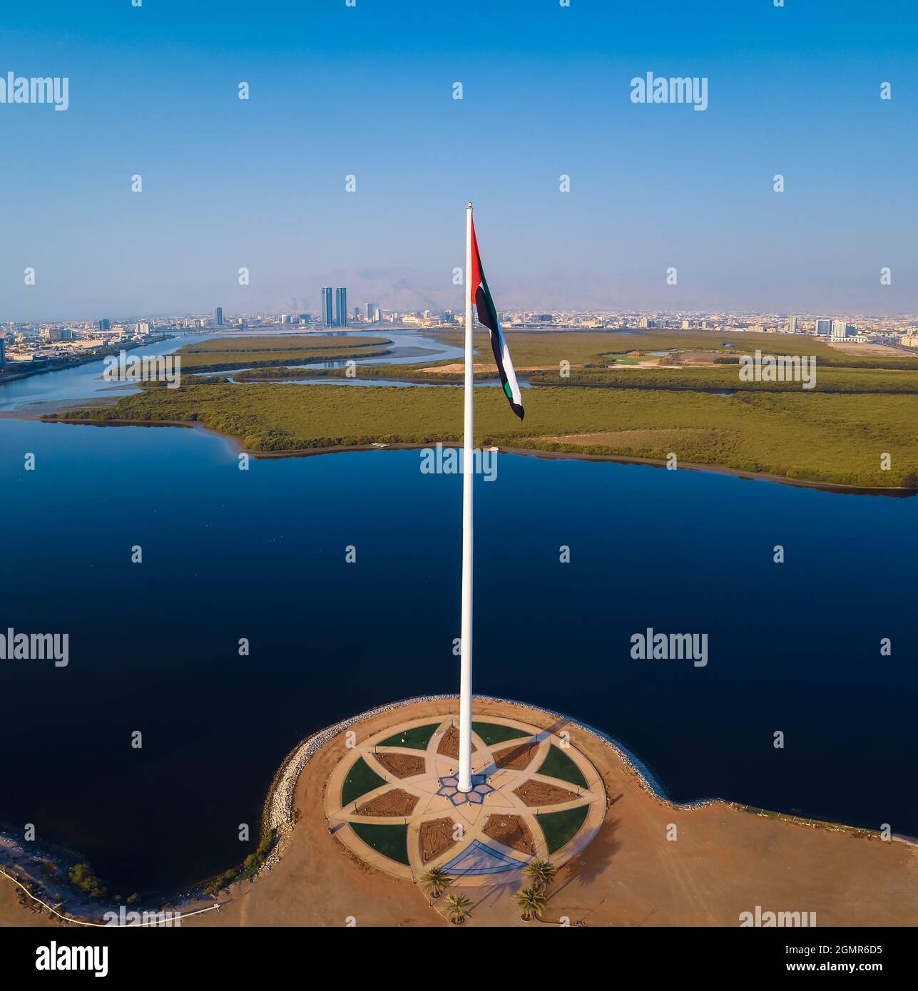 Bandiera nazionale degli Emirati Arabi Uniti e Ras al Khaimah emirano Il punto di riferimento e lo skyline aereo degli Emirati Arabi Uniti del nord vista sopra le mangrovie an Foto Stock