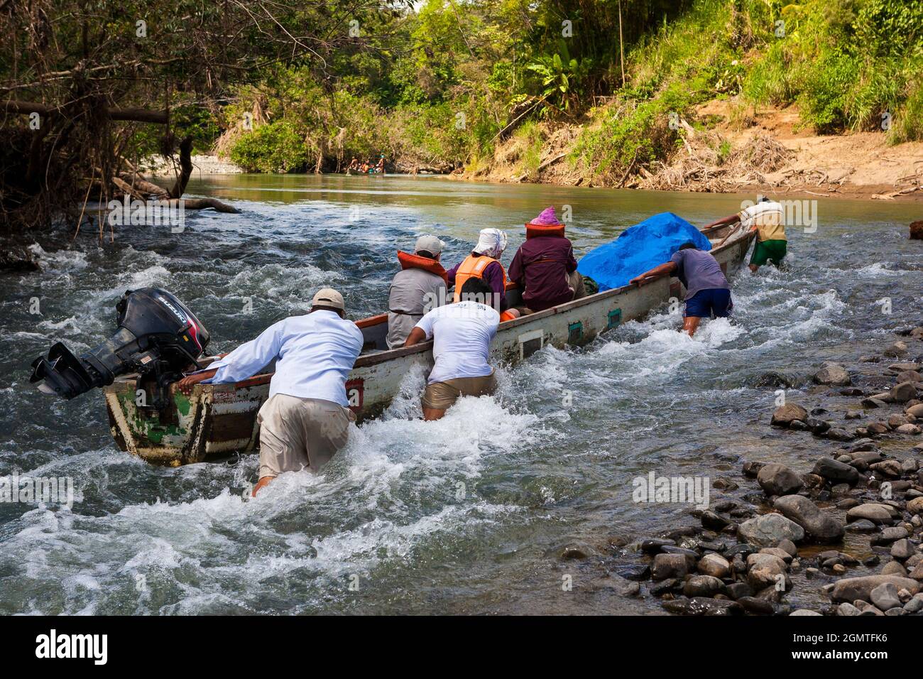 Una canoa in dugotta è in corso di trasporto un rapido a Rio Pequeni, Chagres parco nazionale, Repubblica di Panama, America Centrale. Foto Stock