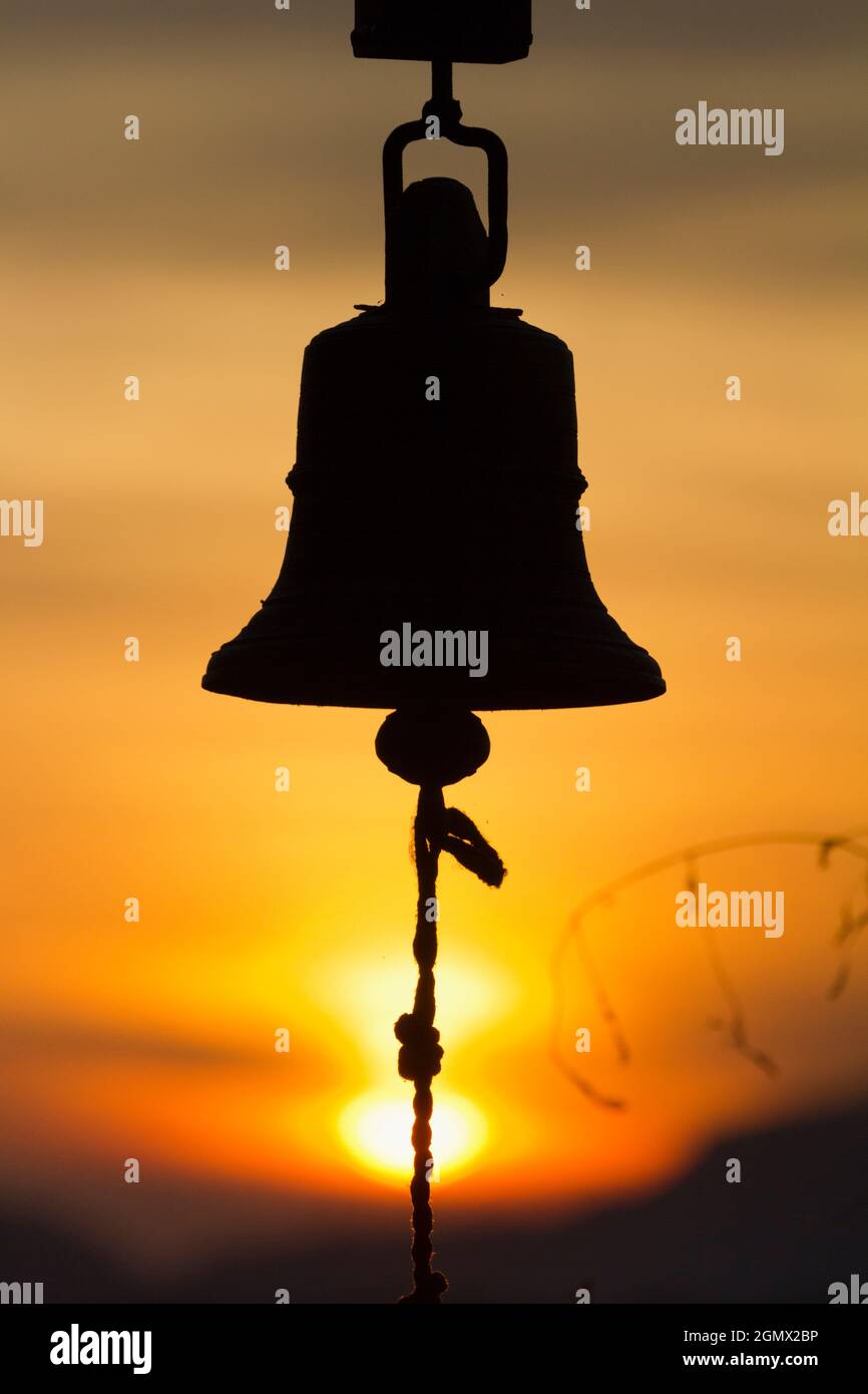 Dambulla, Sri Lanka - 9 febbraio 2014 c'è qualcosa di estremamente suggestivo su una campana che si fa a pedaggio al tramonto, alla morte del giorno... Foto Stock