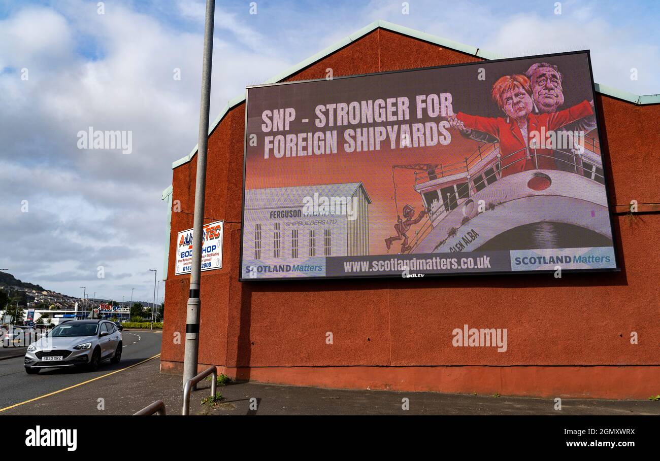 Port Glasgow, Scozia, Regno Unito. 21 settembre 2021. Il gruppo pro UK Union Scotland Matters ha eretto un cartellone fuori dal cantiere Ferguson a Port Glasgow critico per la decisione del governo scozzese di ordinare i futuri traghetti scozzesi con un breve elenco di tre iarde, in Turchia, Polonia o Romania. Il cartellone presenta il leader della SNP e il primo Ministro Nicola Sturgeon e l'ex primo Ministro Alex Salmond in piedi sul prua della linea Titanic con messaggio SNP più forte per i cantieri navali stranieri. Iain Masterton/Alamy Live News. Foto Stock