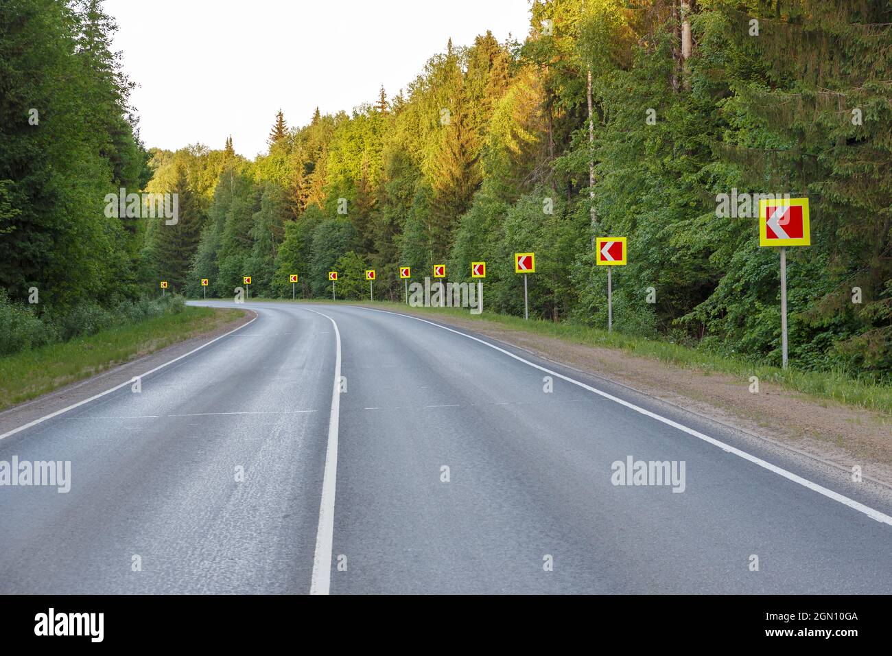 Svolta pericolosa. Segnaletica stradale pericolo curva strada. Foto Stock