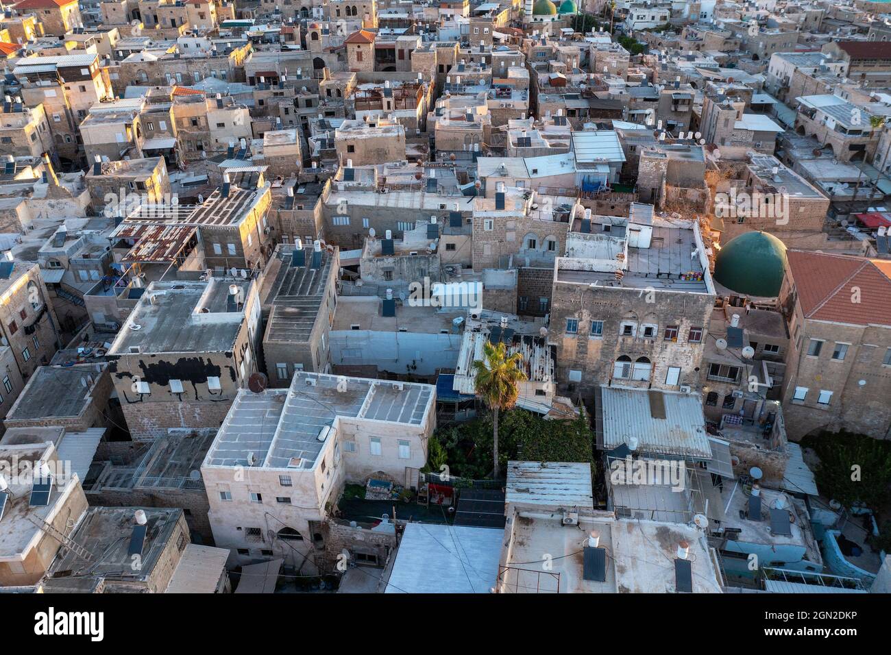 Acri di vecchie case portuali della città e la moschea all'alba, vista aerea. Foto Stock