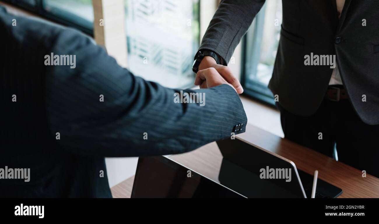 Handshake uomo d'affari per lavoro di squadra della fusione e dell'acquisizione di affari,negoziazione riuscita,mano shake, due uomini d'affari scuotono la mano con il partner a. Foto Stock
