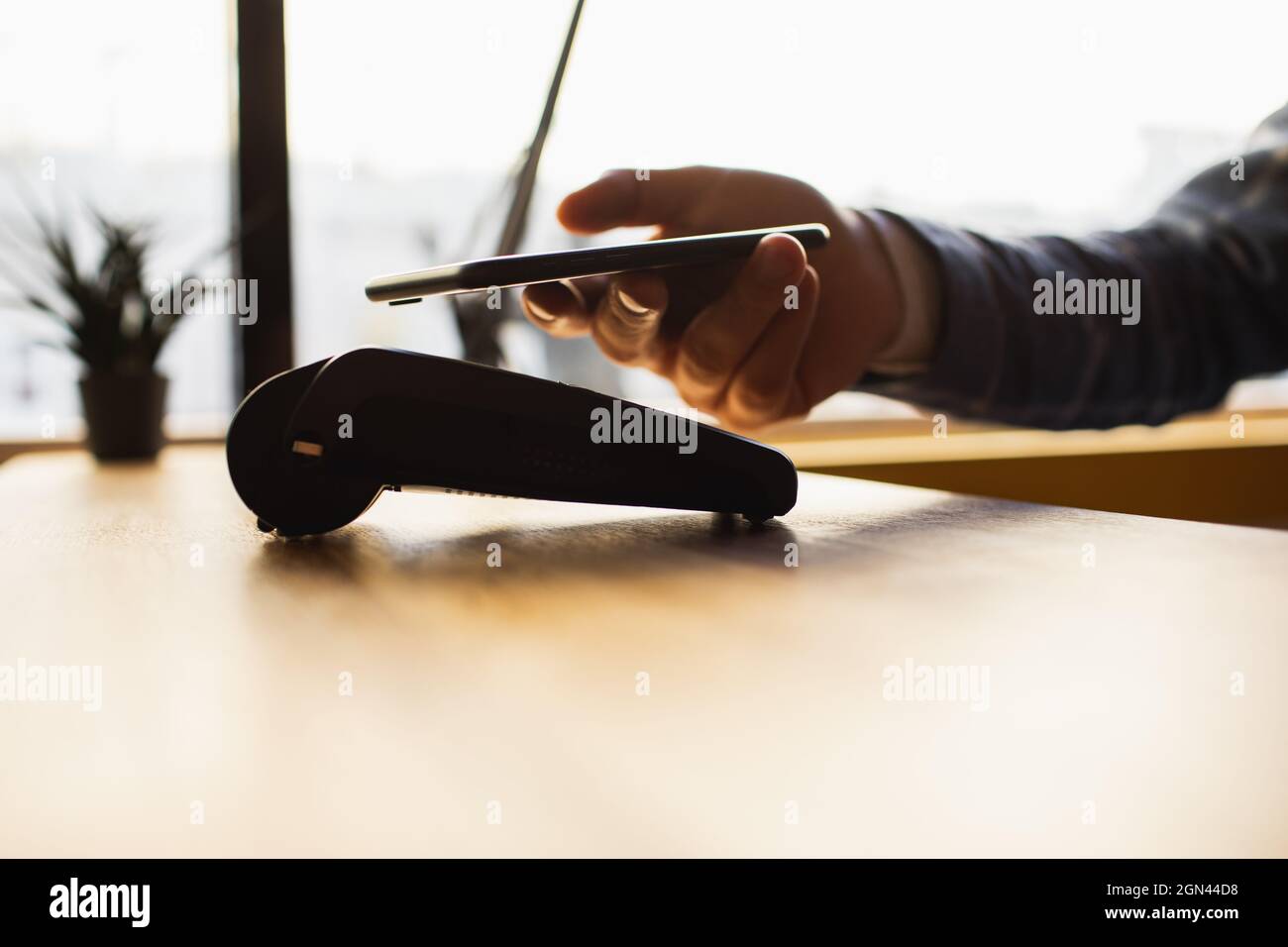 Pagamento effettuato con smartphone utilizzando il sistema nfc e la carta contactless. Foto Stock
